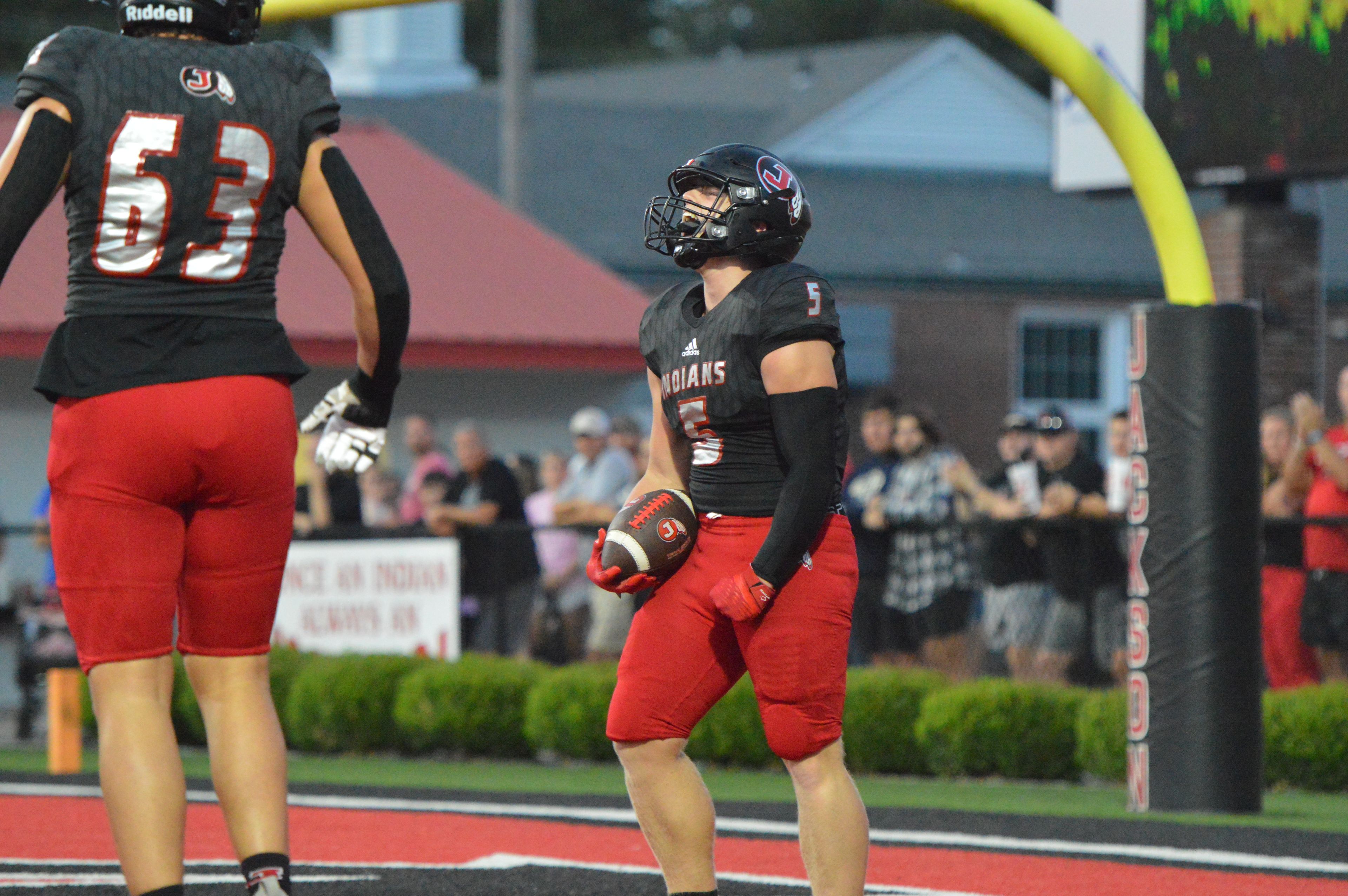 Jackson running back Zach Crump celebrates after scoring the first touchdown of the game for the Indians in their home opener against Farmington on Friday, Sept. 20.