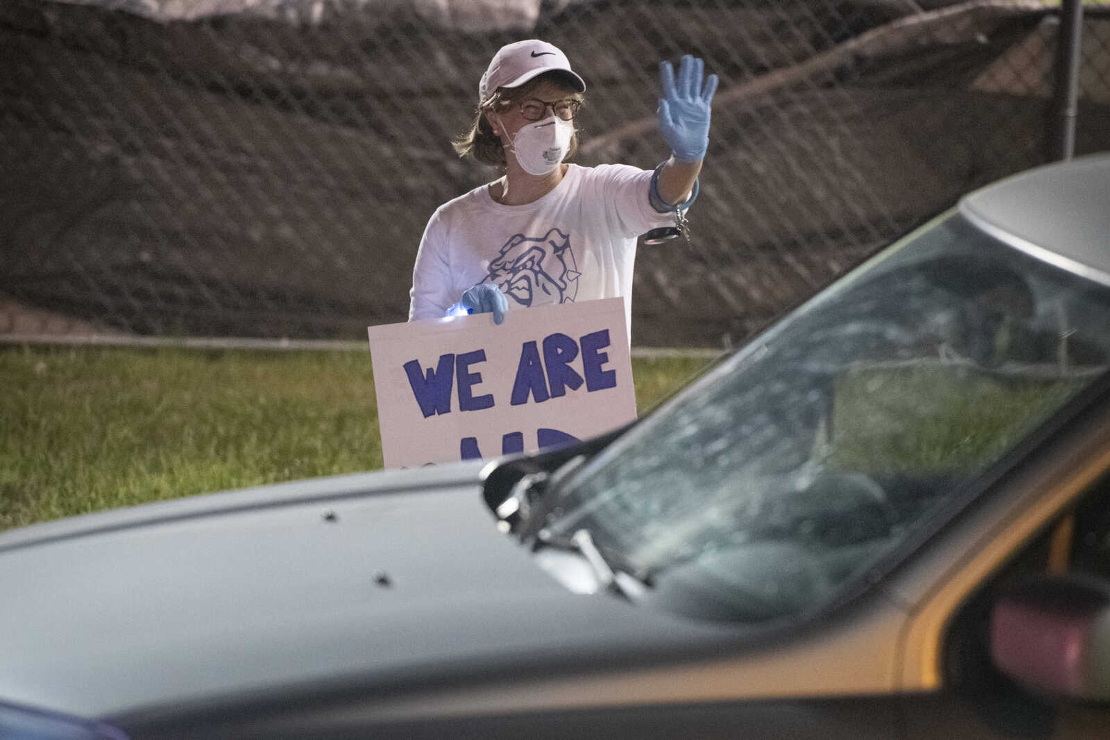 Cindy Maher, an English teacher at Notre Dame Regional High School, waves during a "Friday night lights" senior drive-through event Friday, May 1, 2020, at the school in Cape Girardeau.