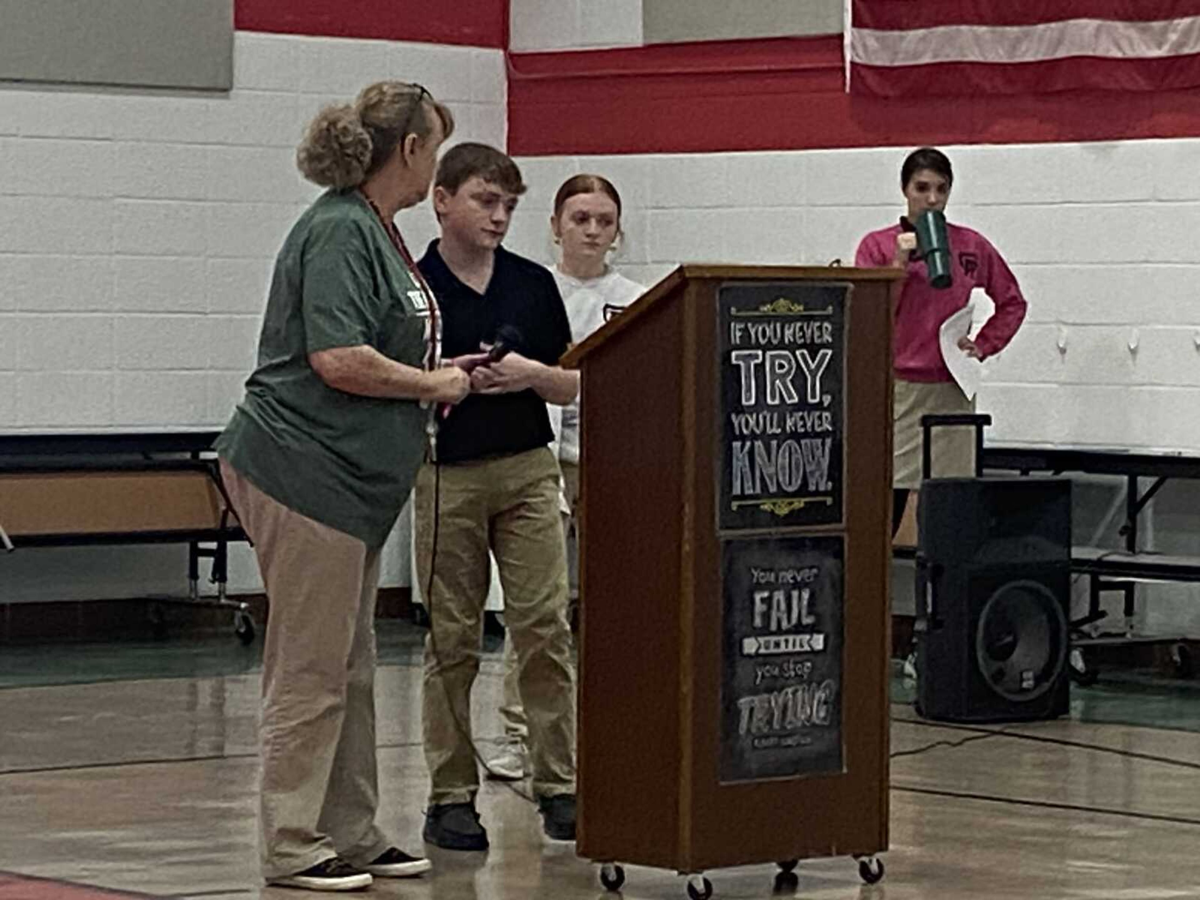 The 8th grade students researched some interesting facts about pi and presented them to the students and staff of Guardian Angel.  Pictured are the Math teacher, Ms. Ann Whistler, and the 8th grade students, Kasyn Seabaugh, Adisyn Seabaugh, and Rylie Priggel.