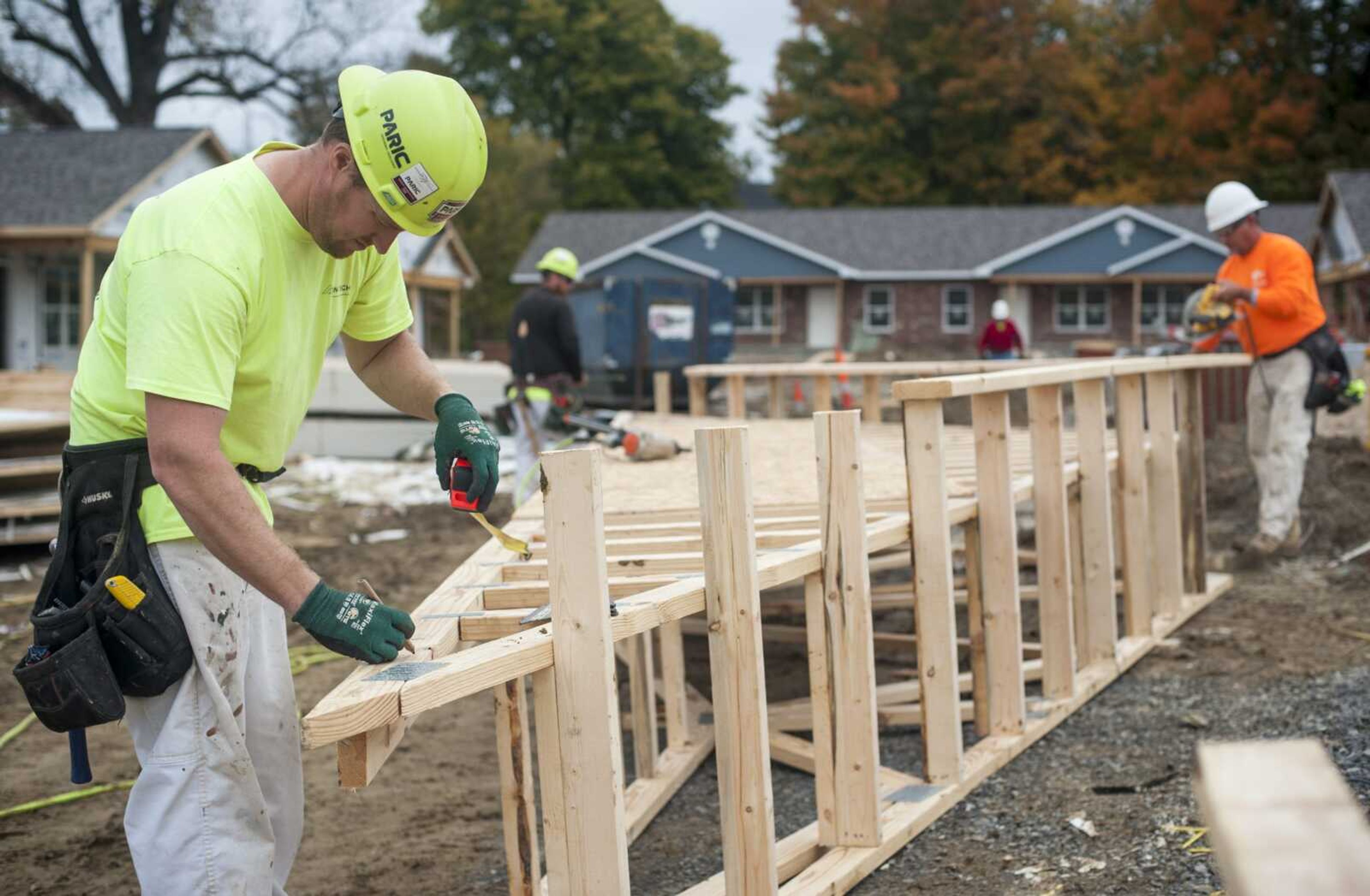 Carpenter Jason Inman of Festus, Missouri, left, marks a measurement on a truss Monday at the future site of Liberty Apartments in Cape Girardeau.