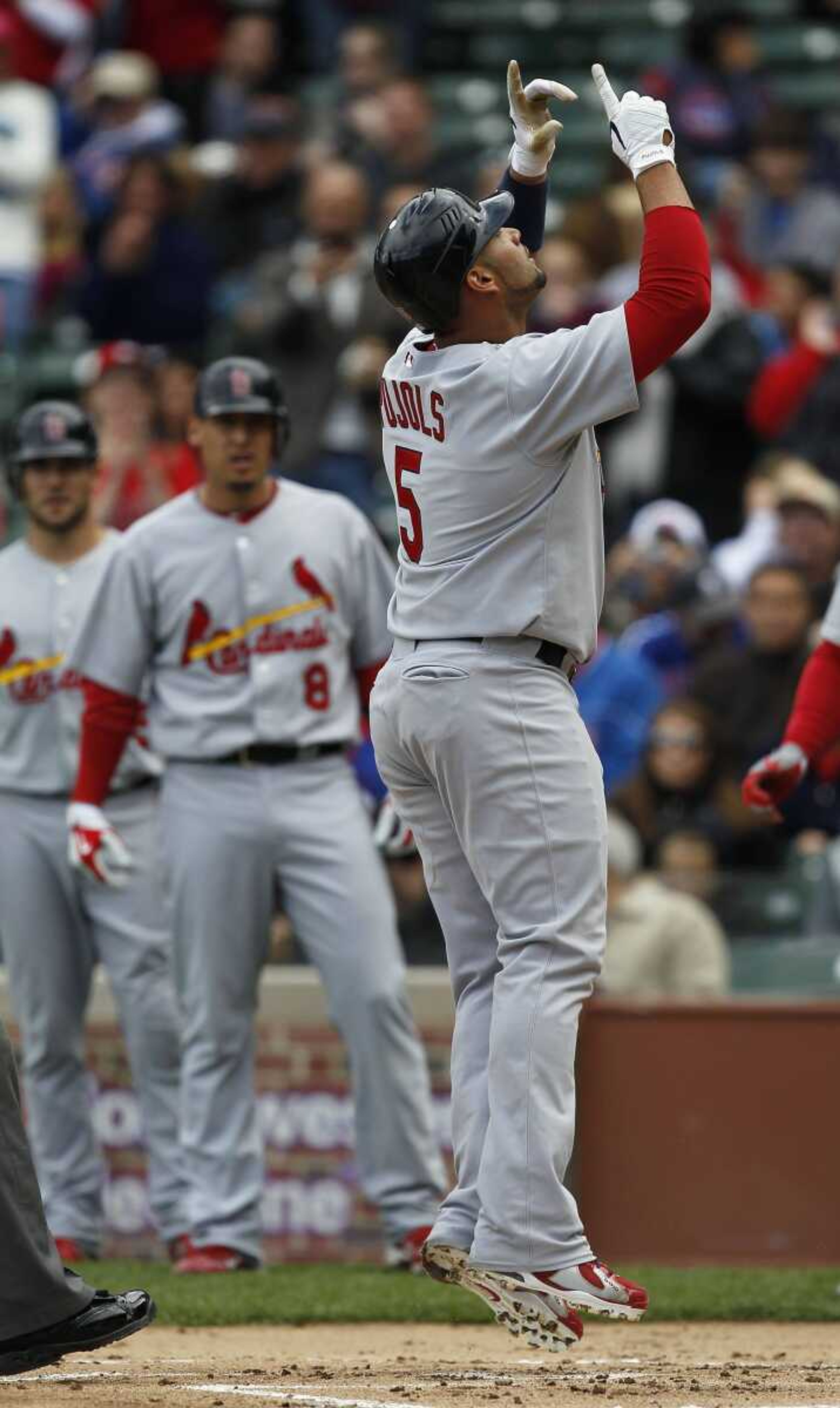 Cardinals first baseman Albert Pujols points to the sky after hitting a three-run home run during the first inning Sunday against the Cubs in Chicago. (Jose M. Osorio ~ Chicago-Tribune)