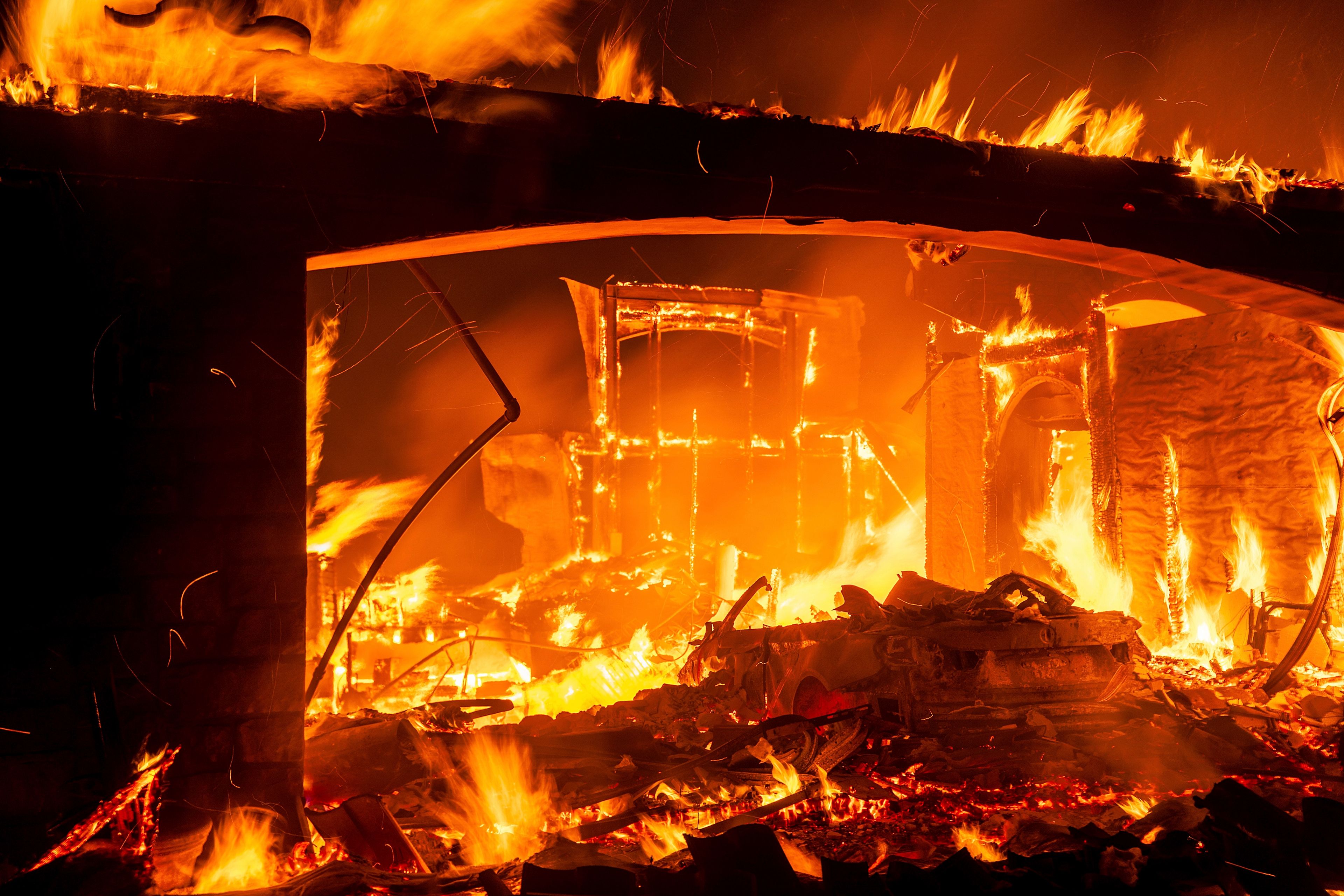 Flames consume a home as the Mountain Fire burns in Camarillo, Calif., Nov. 6, 2024. (AP Photo/Noah Berger)