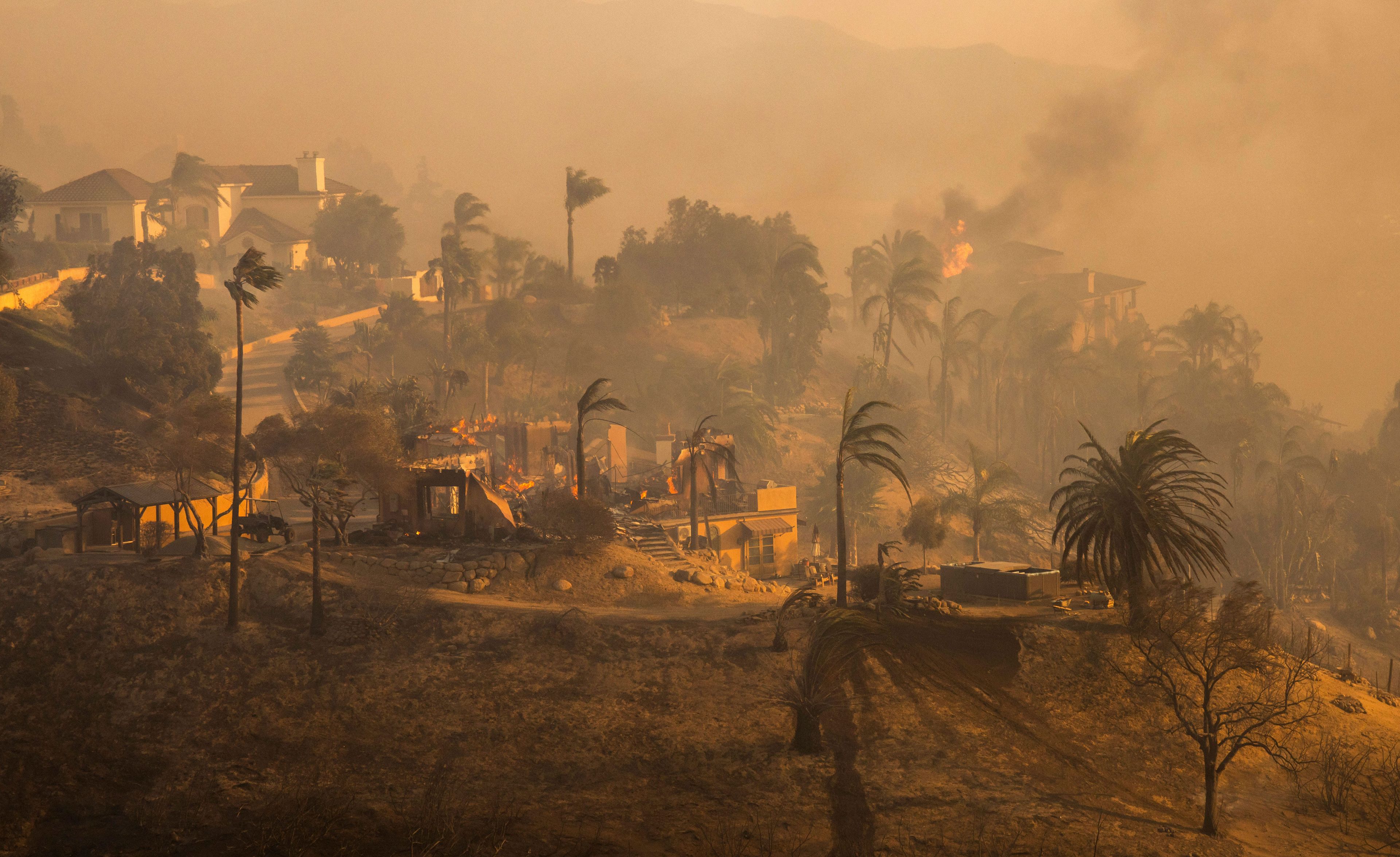 Destroyed homes sit among smoldering hills in the Mountain fire, Wednesday, Nov. 6, 2024, in Camarillo, Calif. (AP Photo/Marcio Jose Sanchez)