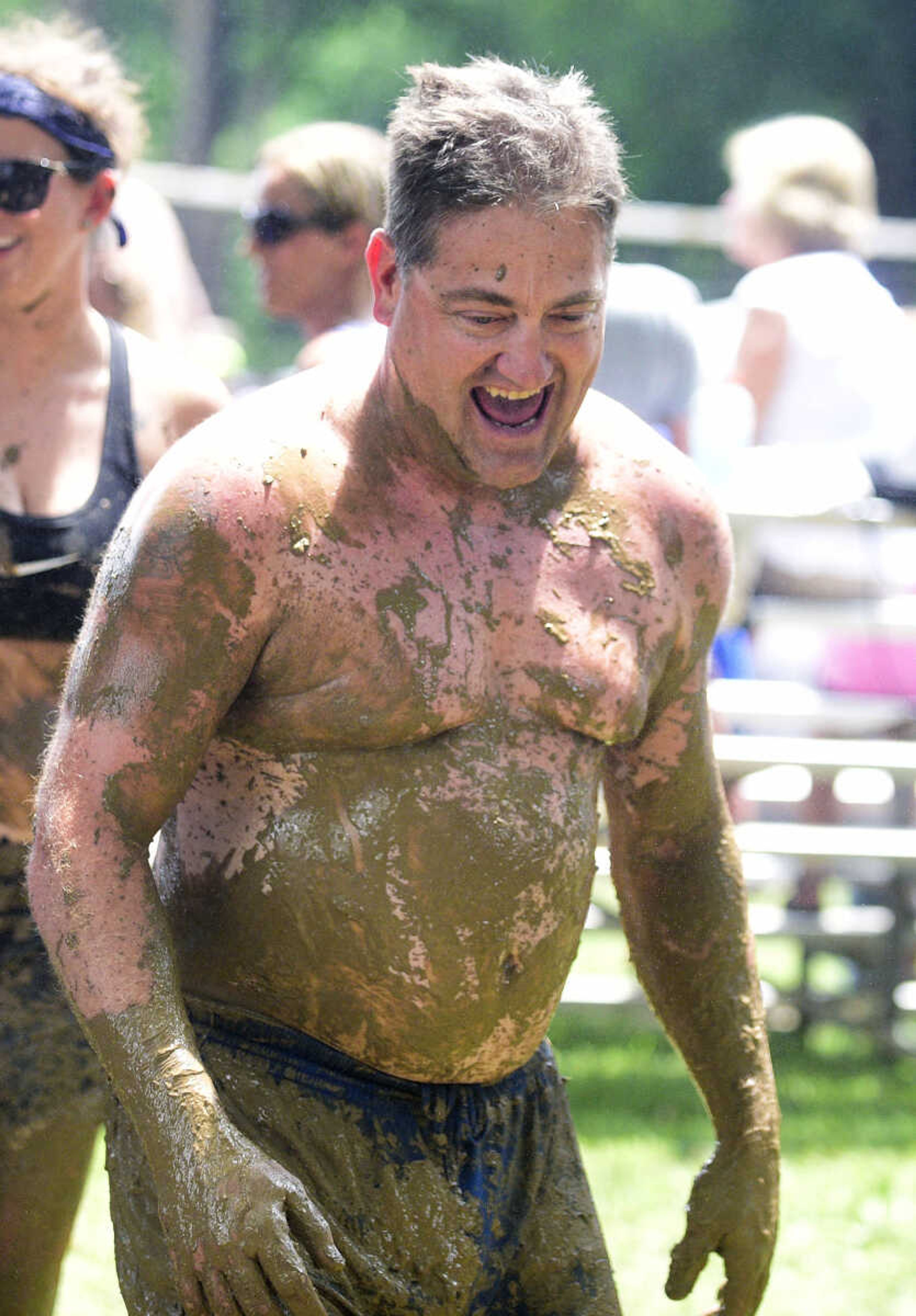 Team members hit the wash station after playing mud volleyball during the Fourth of July celebration on Tuesday at Jackson City Park.