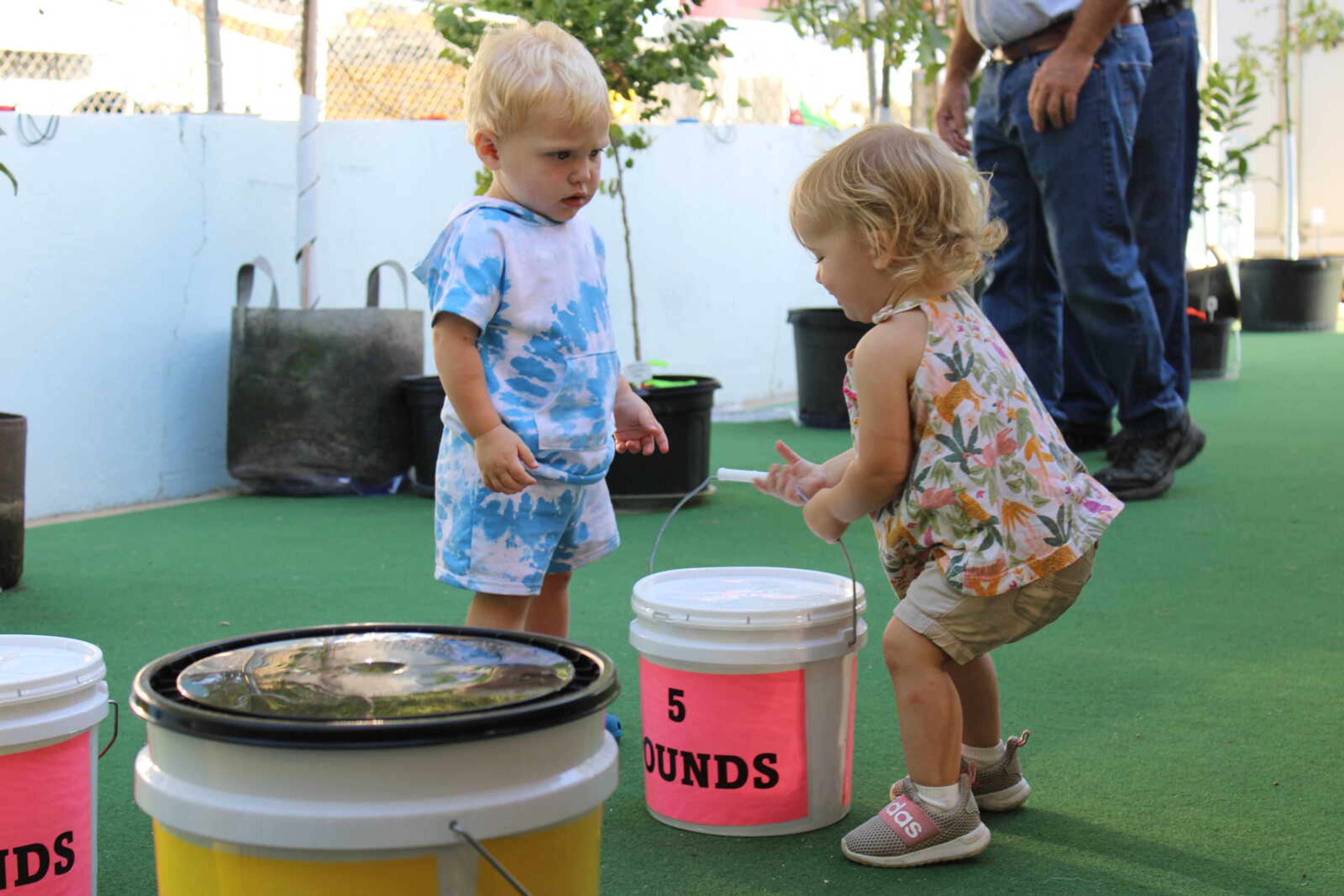 Ava White shows Kai Hendricks how to do the bucket lift.