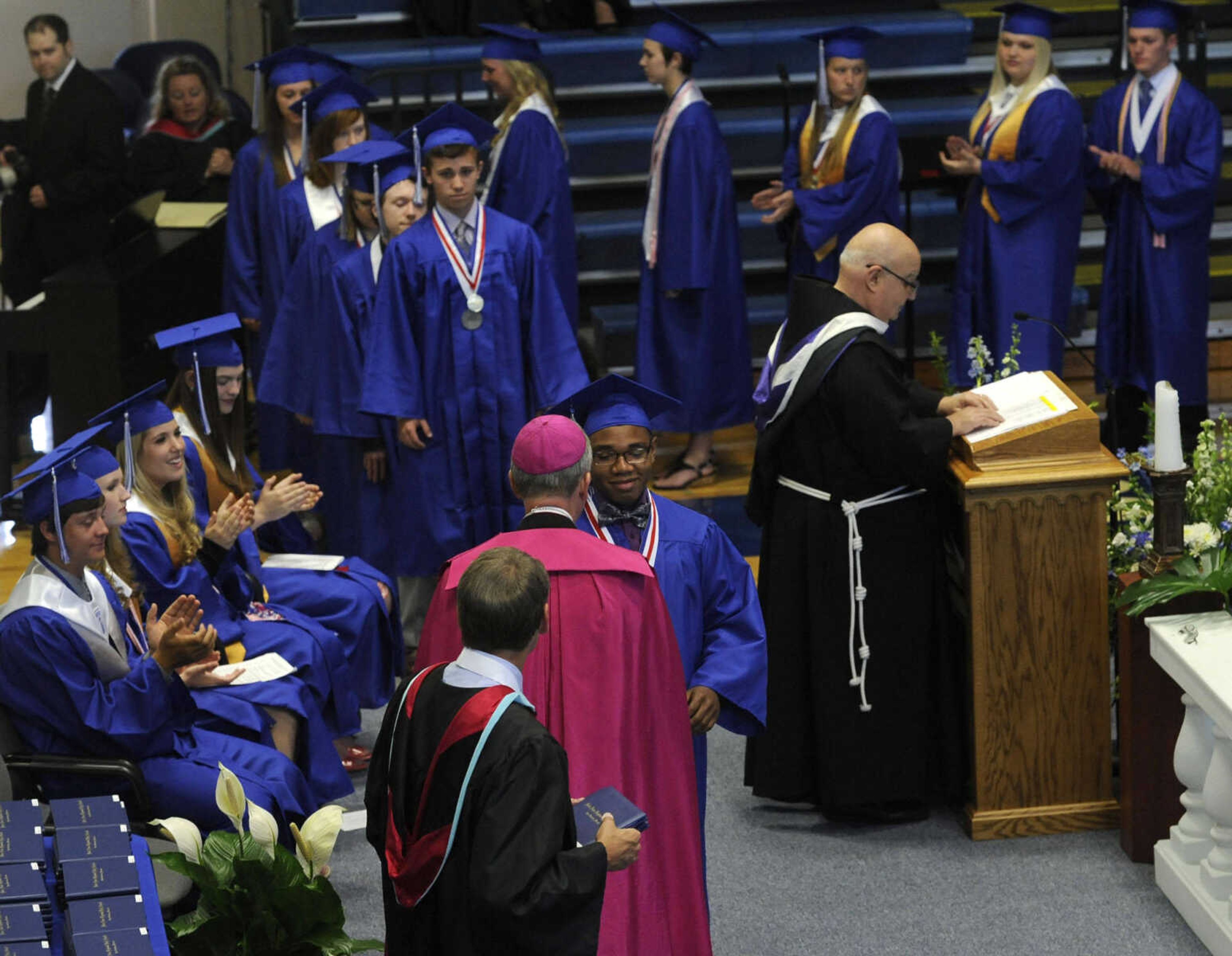 Jordan Williamson receives a diploma from Bishop James Vann Johnson at the Notre Dame Regional High School commencement Sunday, May 18, 2014.