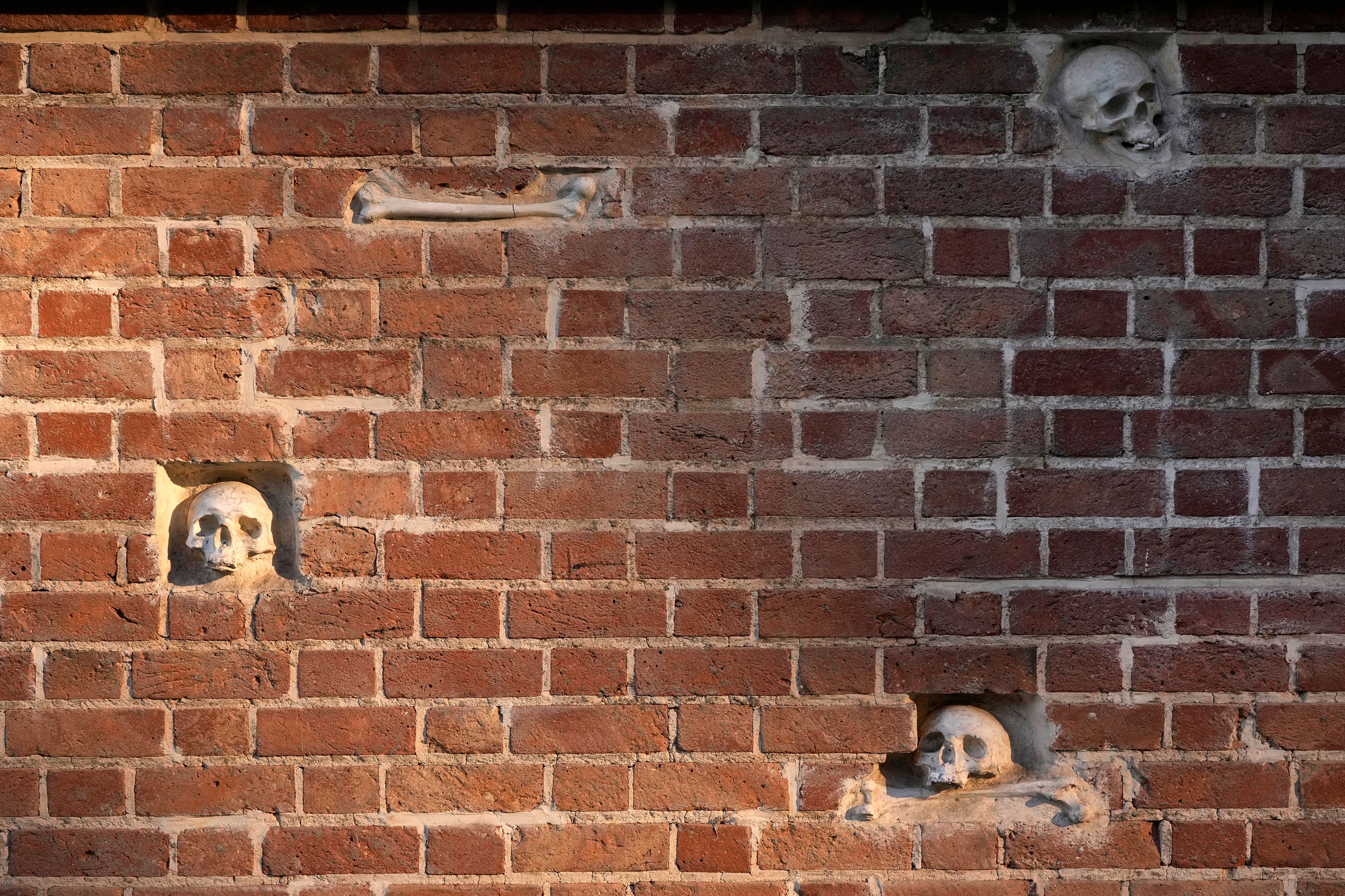 Artificial skulls and bones are placed into the exterior wall of the former U.S. Embassy, which has been turned into an anti-American museum, in Tehran, Iran, Tuesday, Oct. 22, 2024. (AP Photo/Vahid Salemi)