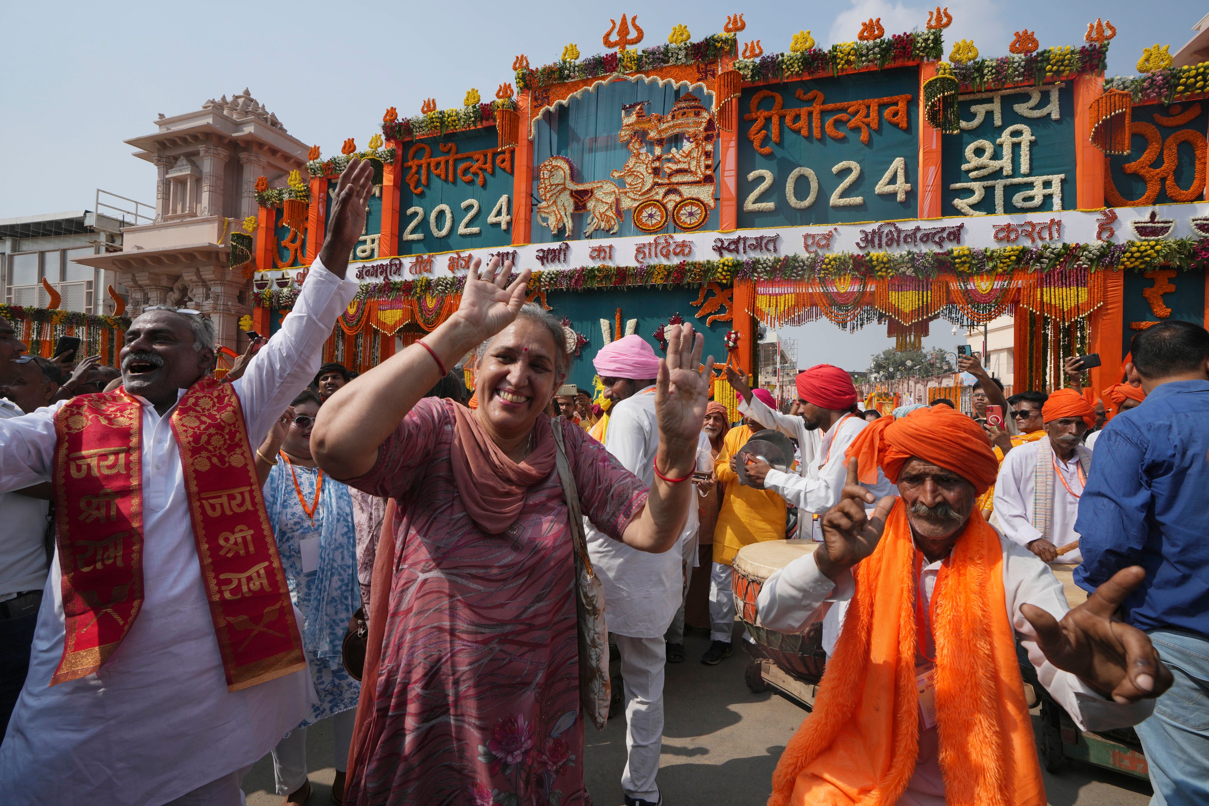 Hindu devotees dance during a street procession on the banks of the Saryu river on the morning of Deepotsav celebrations, an event organized by the Uttar Pradesh state government on the eve of Diwali, in Ayodhya, India, Wednesday, Oct. 30, 2024. (AP Photo/Rajesh Kumar Singh)