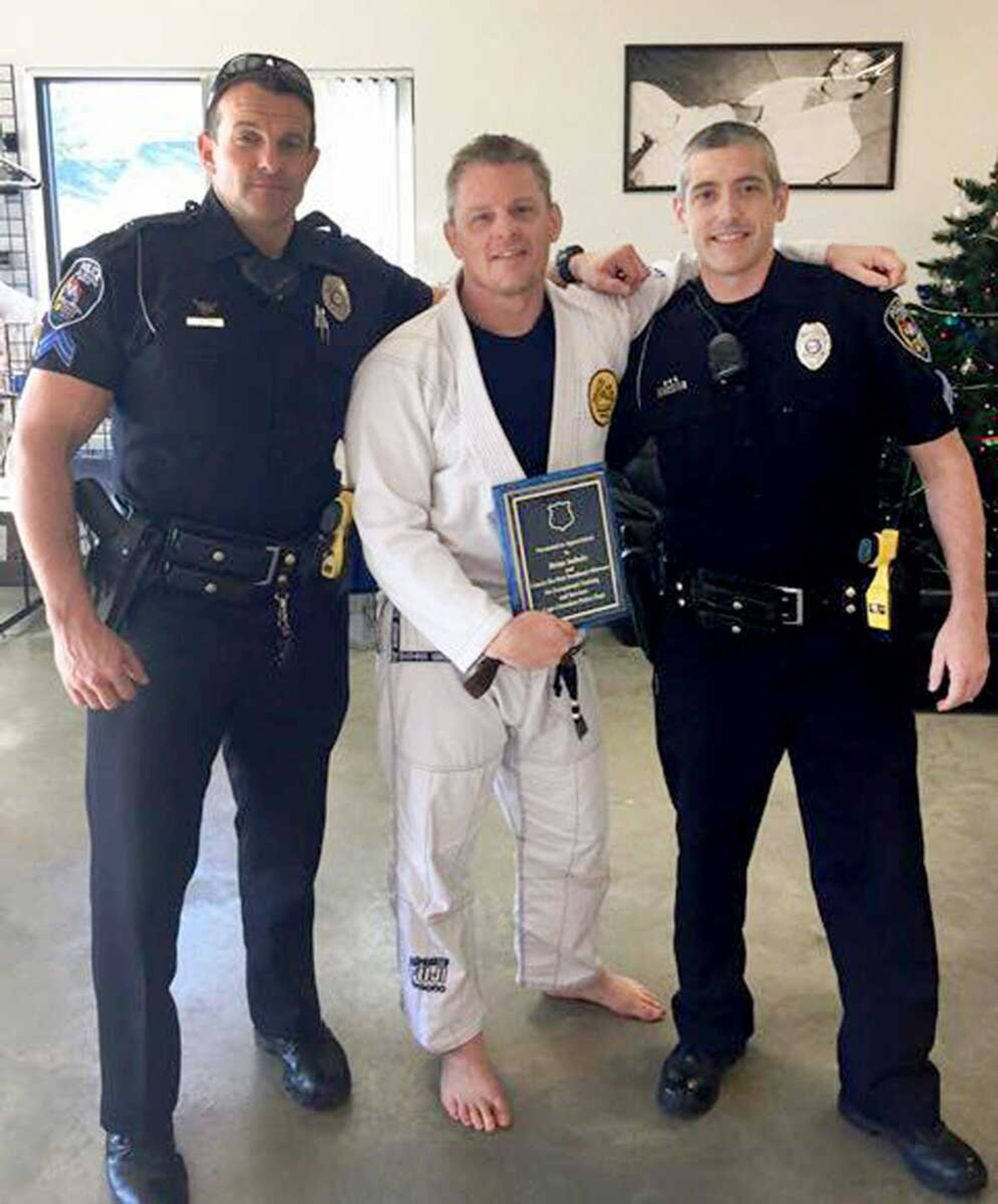 Gracie Jiu-Jitsu of Southeast Missouri instructor Brian Imholz, center, poses for a photo with Cape Girardeau Police Sgt. Joey Hann (left) and Sgt. Adam Glueck. Imholz instructs several Cape Girardeau officers on self-defense techniques. (Cape Girardeau Police Department)