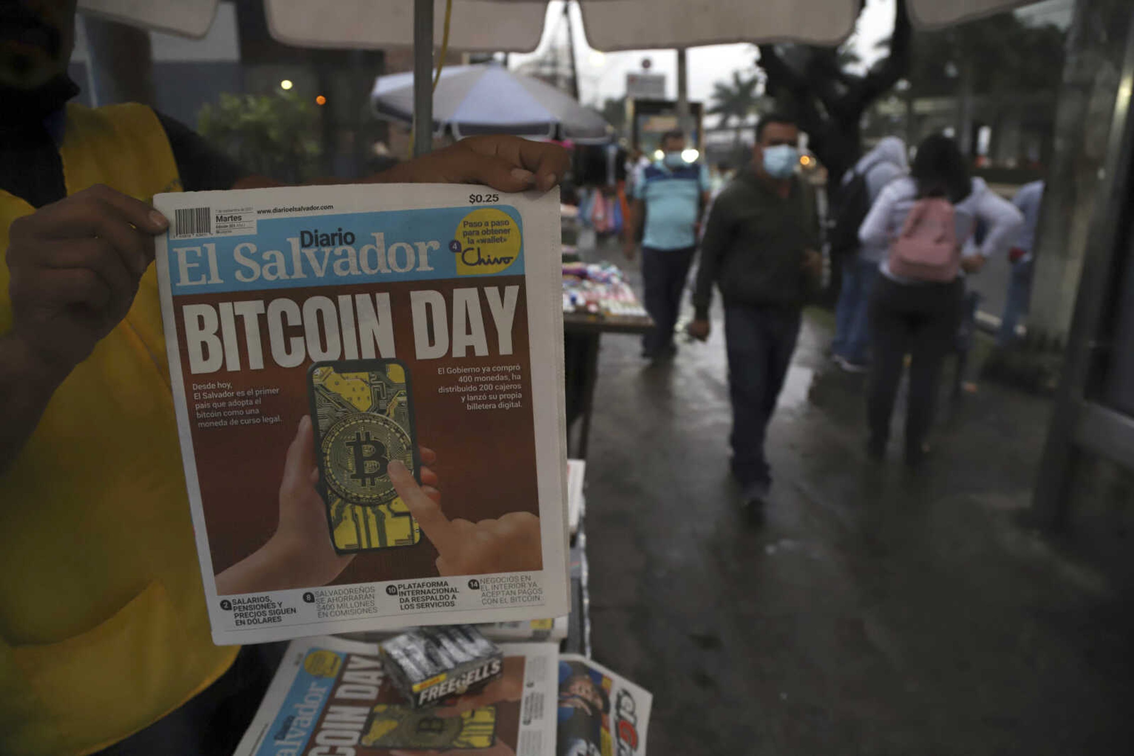 A newspaper vendor shows the front page of a state-run newspaper carrying the headline "Bitcoin Day" on Tuesday in San Salvador, El Salvador.