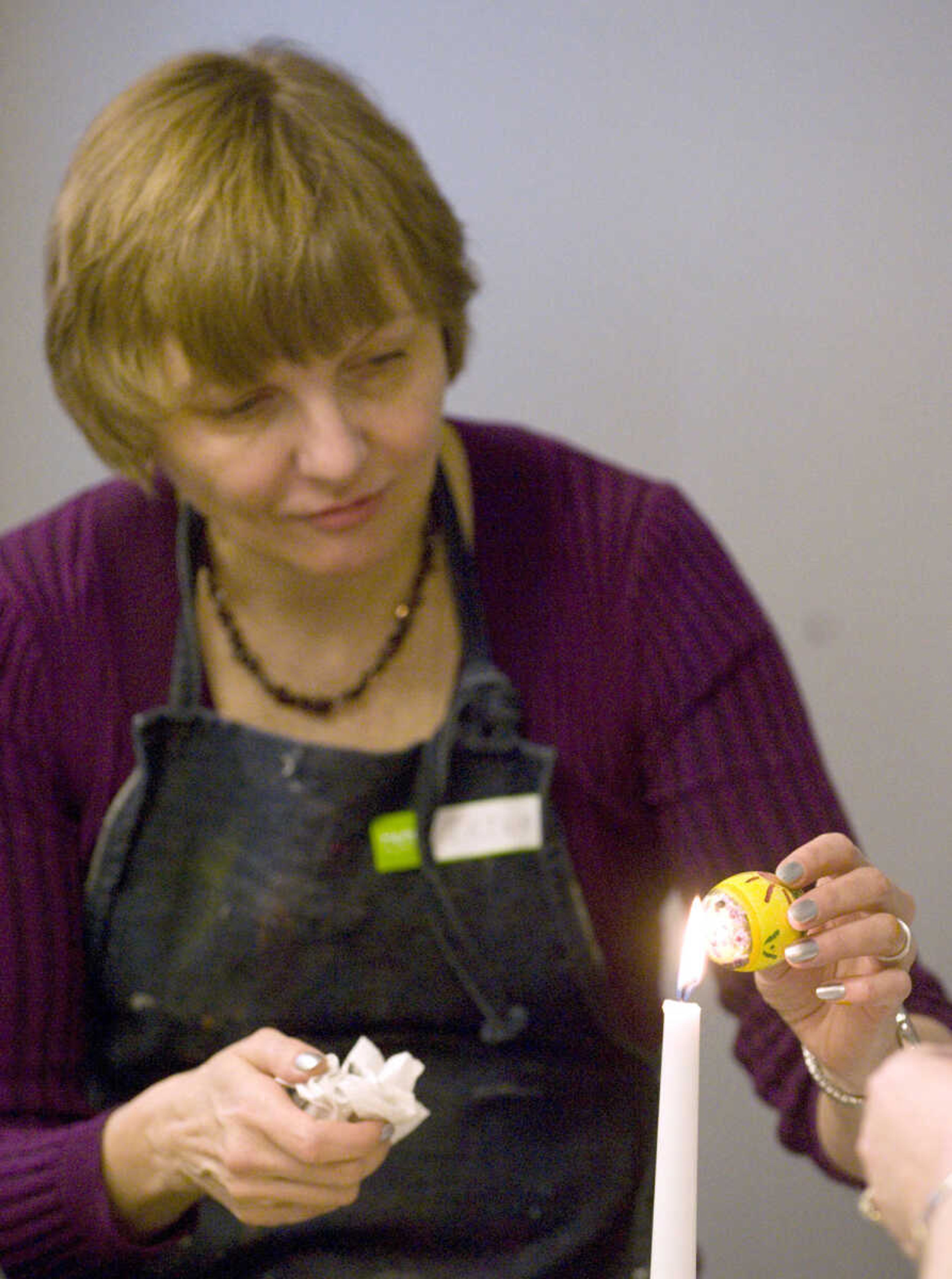 LAURA SIMON ~ lsimon@semissourian.com
Irina Stallion melts the beeswax off of her dyed egg Tuesday, March 19, 2013 during the Wonderful World of Pysanky workshop at Southeast Missouri State University's River Campus.