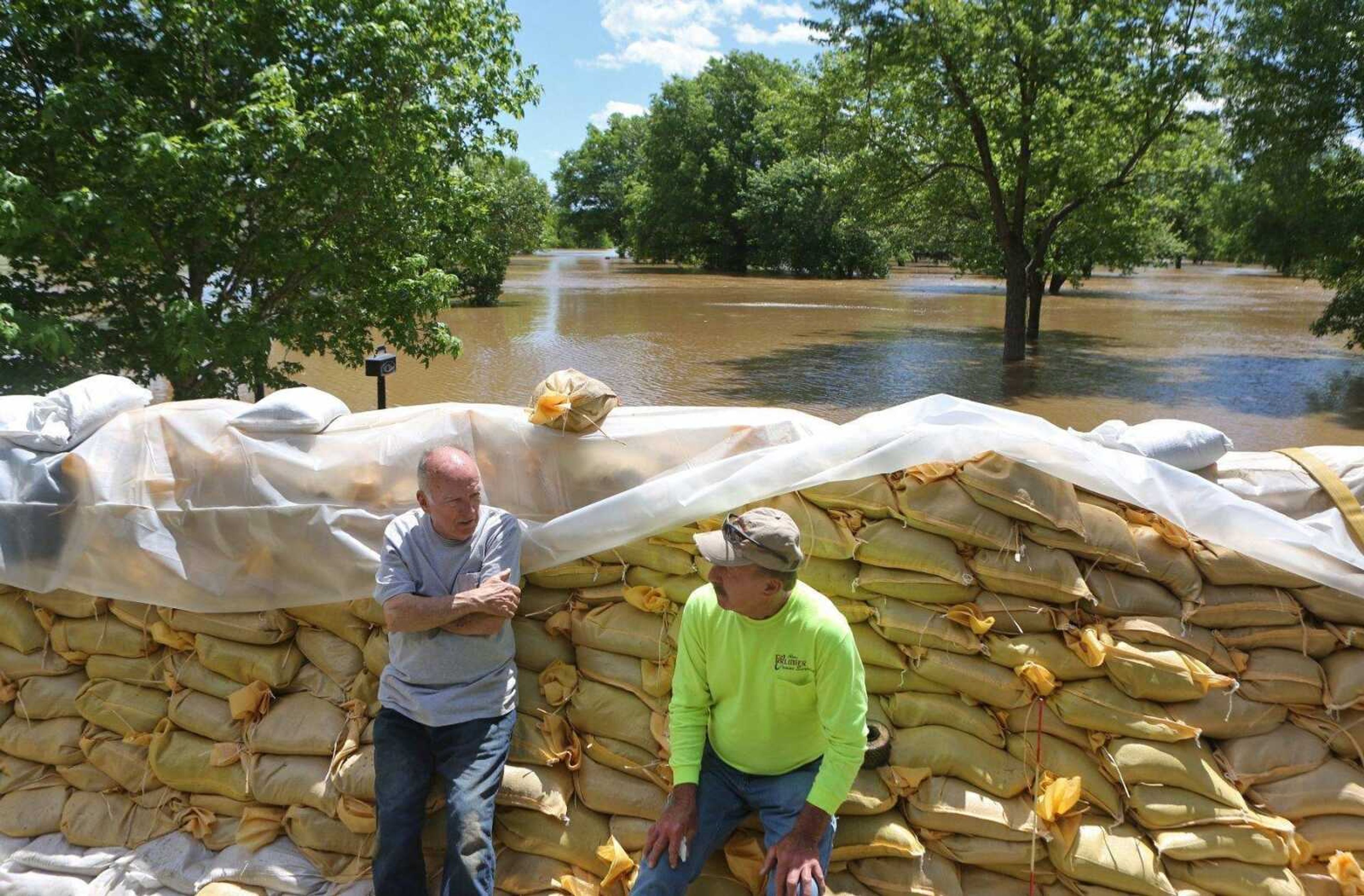 Homeowner Tom Bell, 71, left, and his friend Stan Erlinger take a break from sandbagging and flood preparation Tuesday in Fenton, Missouri. Bell is hoping he is better prepared than he was in 2015, when the Meramec River did a great deal of damage to his home.