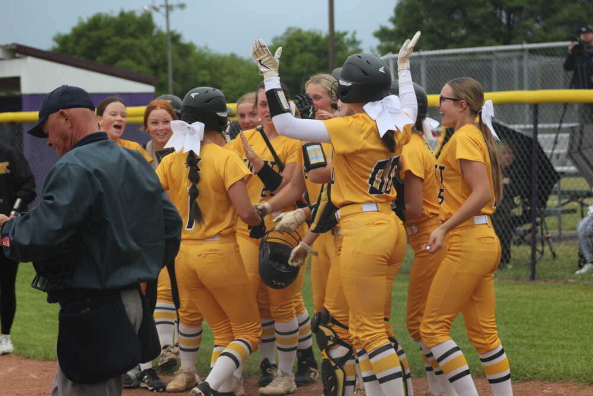 Kennett Lady Indians gather at the plate last April at Indian Park to celebrate pitcher Handley McAtee's grand slam home run.
