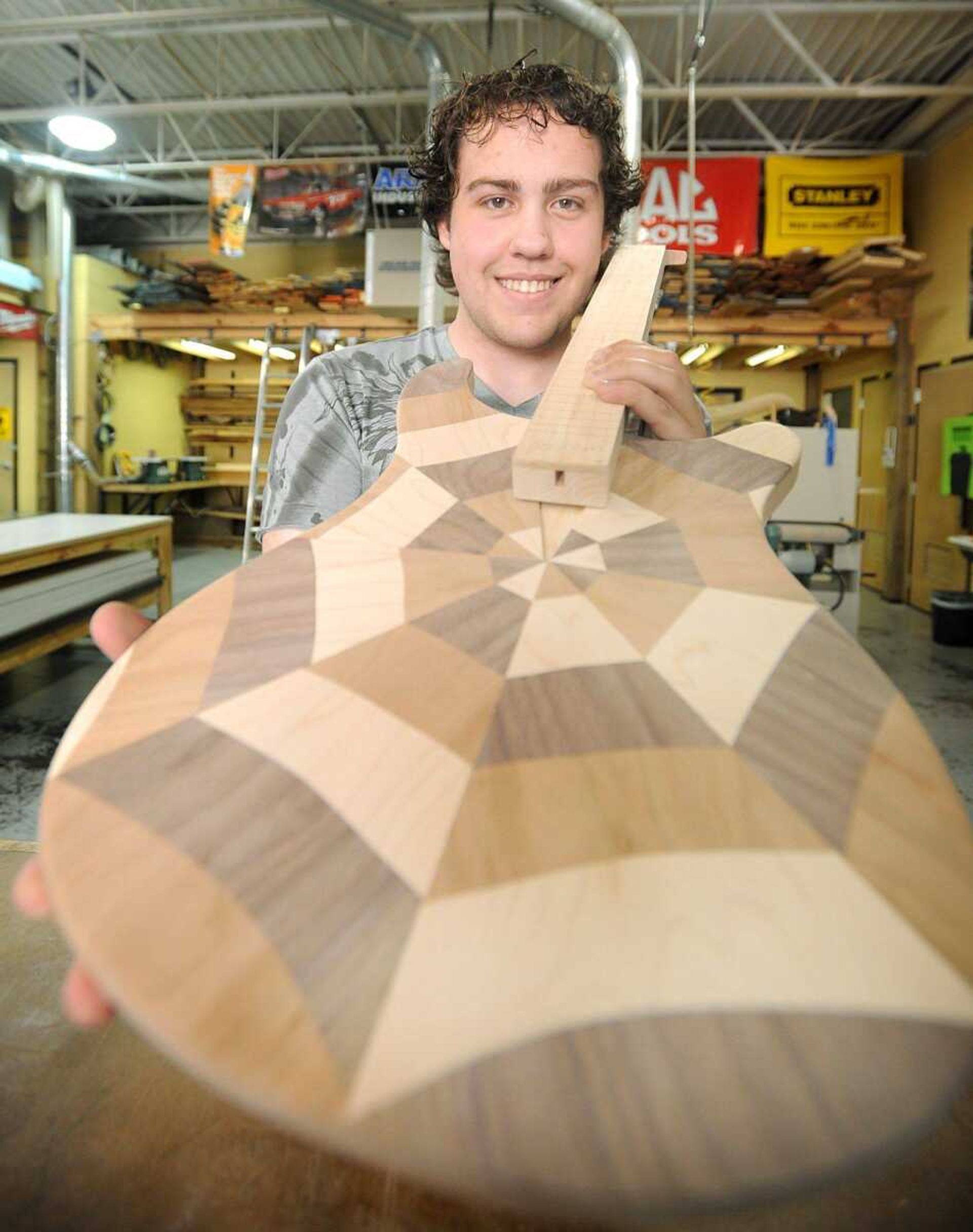 Zack Perkins shows his work-in-progress guitar Tuesday. (Laura Simon)