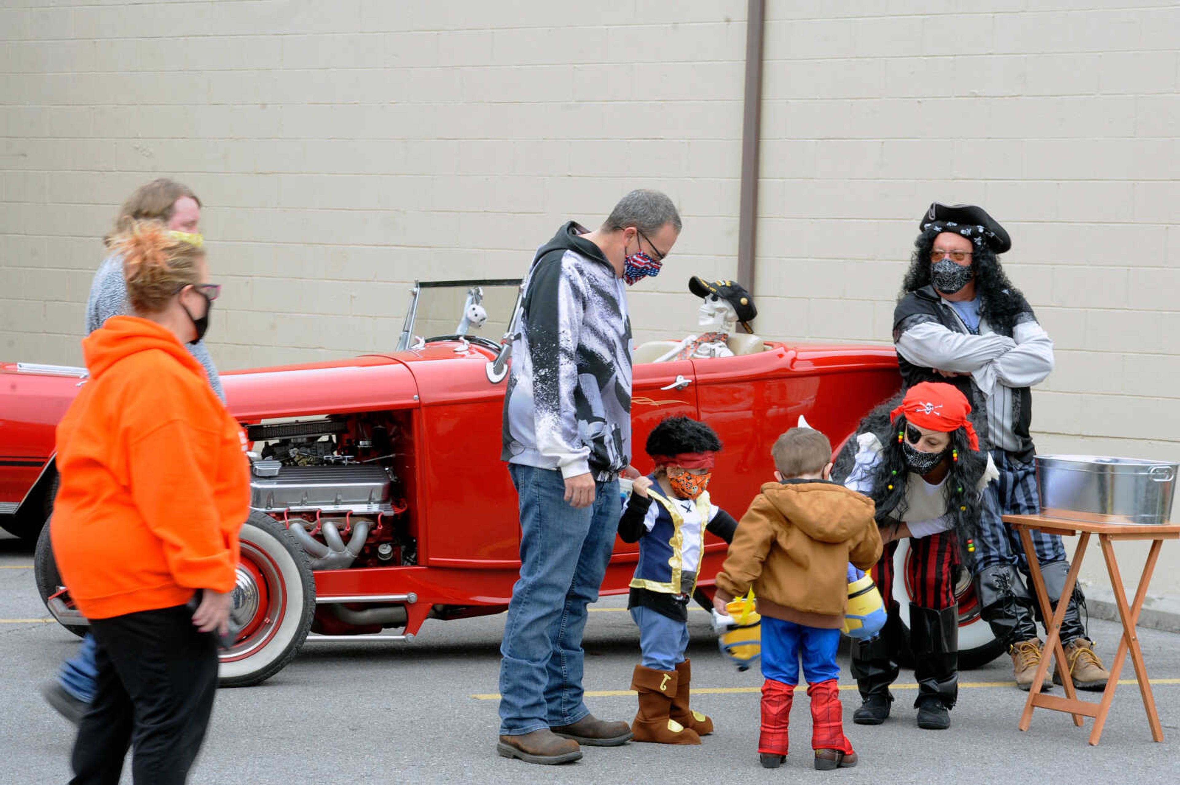 Jodi Templeton passes out candy to kids in costumes at the Monster Mash Car Bash on Sunday, Oct. 25, 2020, in downtown Cape Girardeau. Jodi and her husband, Bob (behind), dressed as pirates this year and won the 'Best Costume' award at the event, hosted by Old Town Cape, Inc.&nbsp;