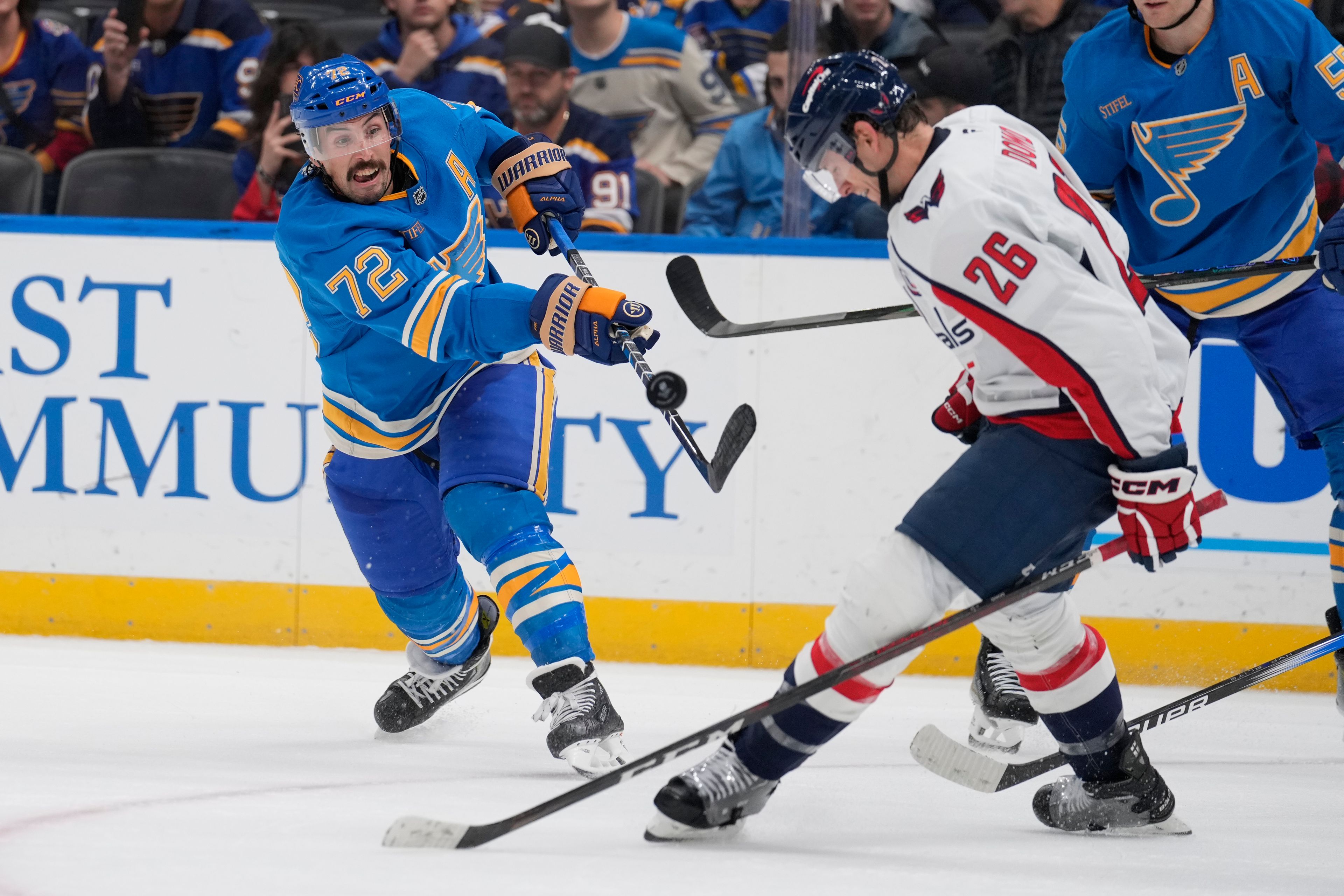 St. Louis Blues' Justin Faulk (72) shoots past Washington Capitals' Nic Dowd (26) during the second period of an NHL hockey game Saturday, Nov. 9, 2024, in St. Louis. (AP Photo/Jeff Roberson)