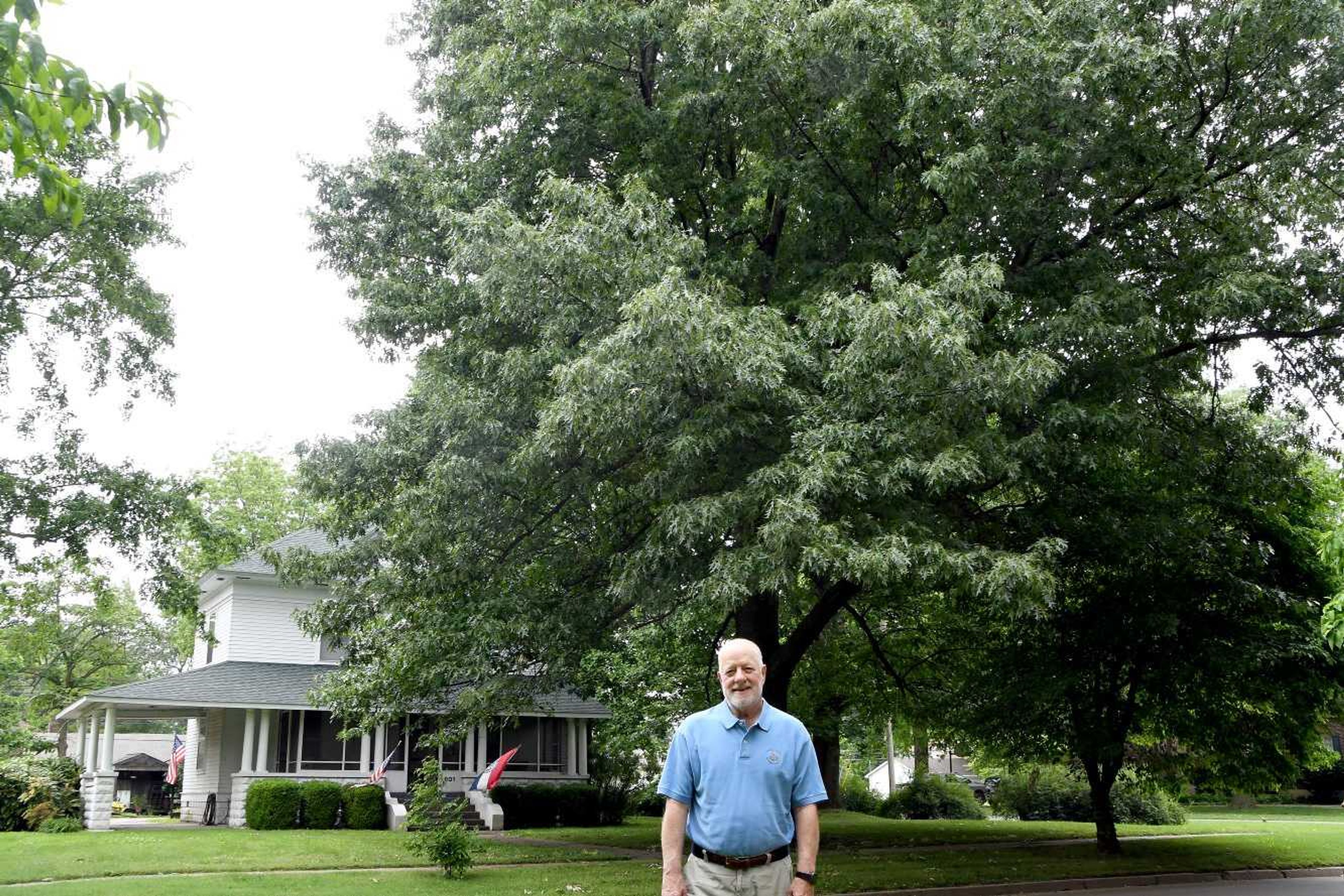 Riley Bock, Camden Bock's father, stands before an oak tree at the family home. Camden Bock's parents, Riley and Jill Bock, planted the tree on the occasion of their son's birth.