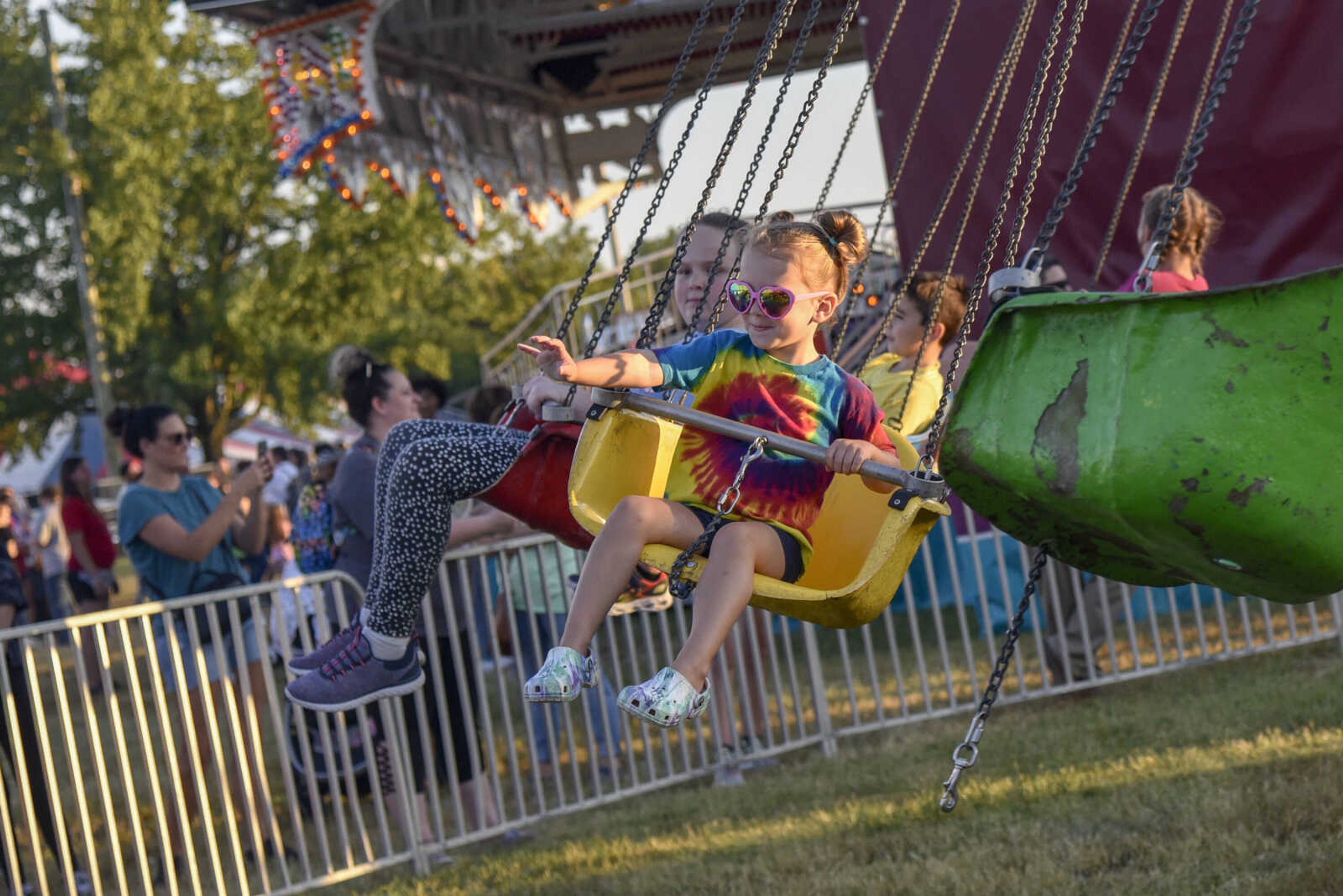 Elsie Baker, 4, waves to her mother while on the swing ride during the SEMO District Fair Wednesday, Sept. 15, 2021 in Cape Girardeau.