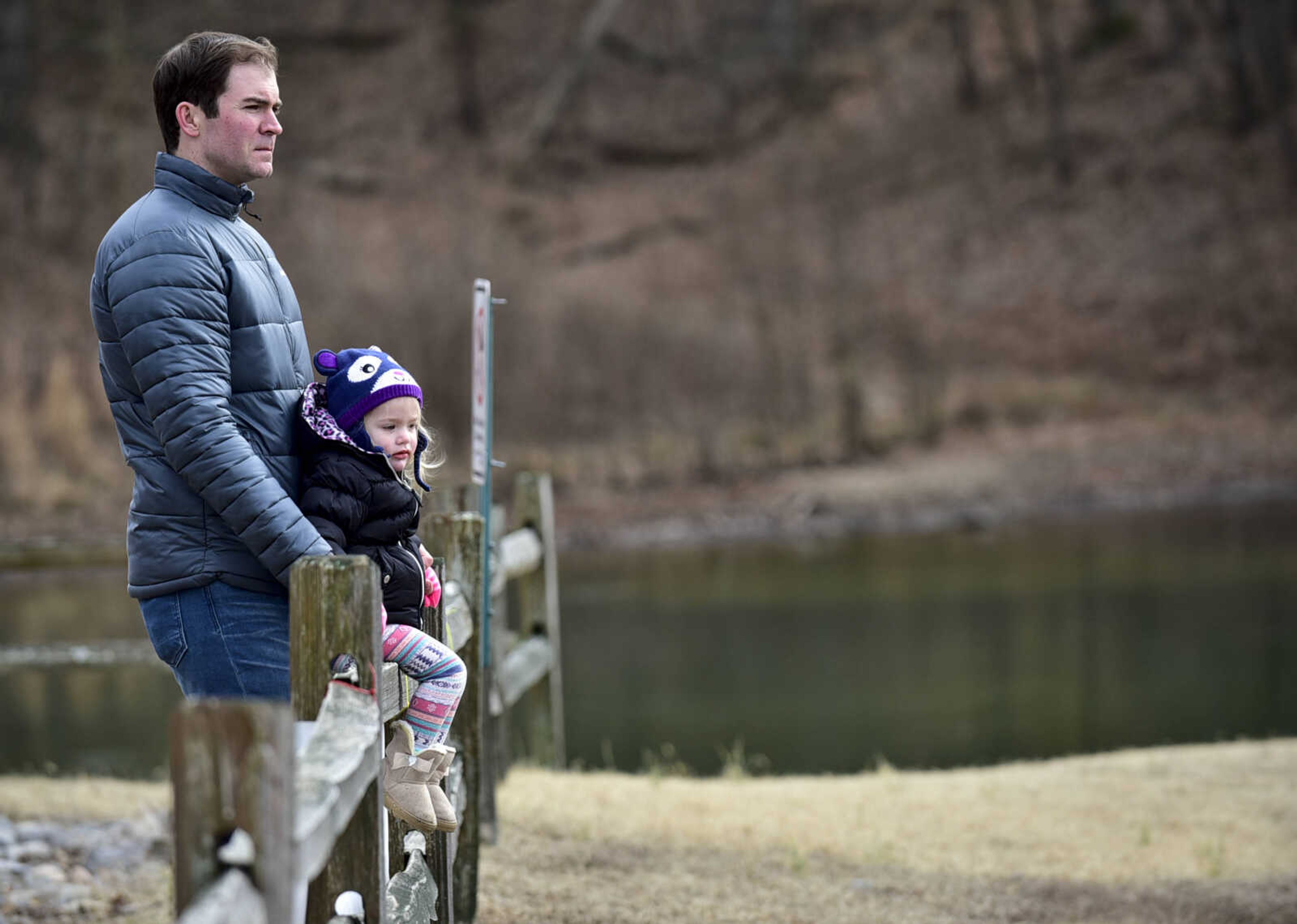 Brent Presser holds his daughter, Joanie, 2, while as she sits on a fence outside of Lake Boutin before the start of the Polar Plunge benefit for Special Olympics Missouri on Saturday, Feb. 3, 2018, at Trail of Tears State Park.