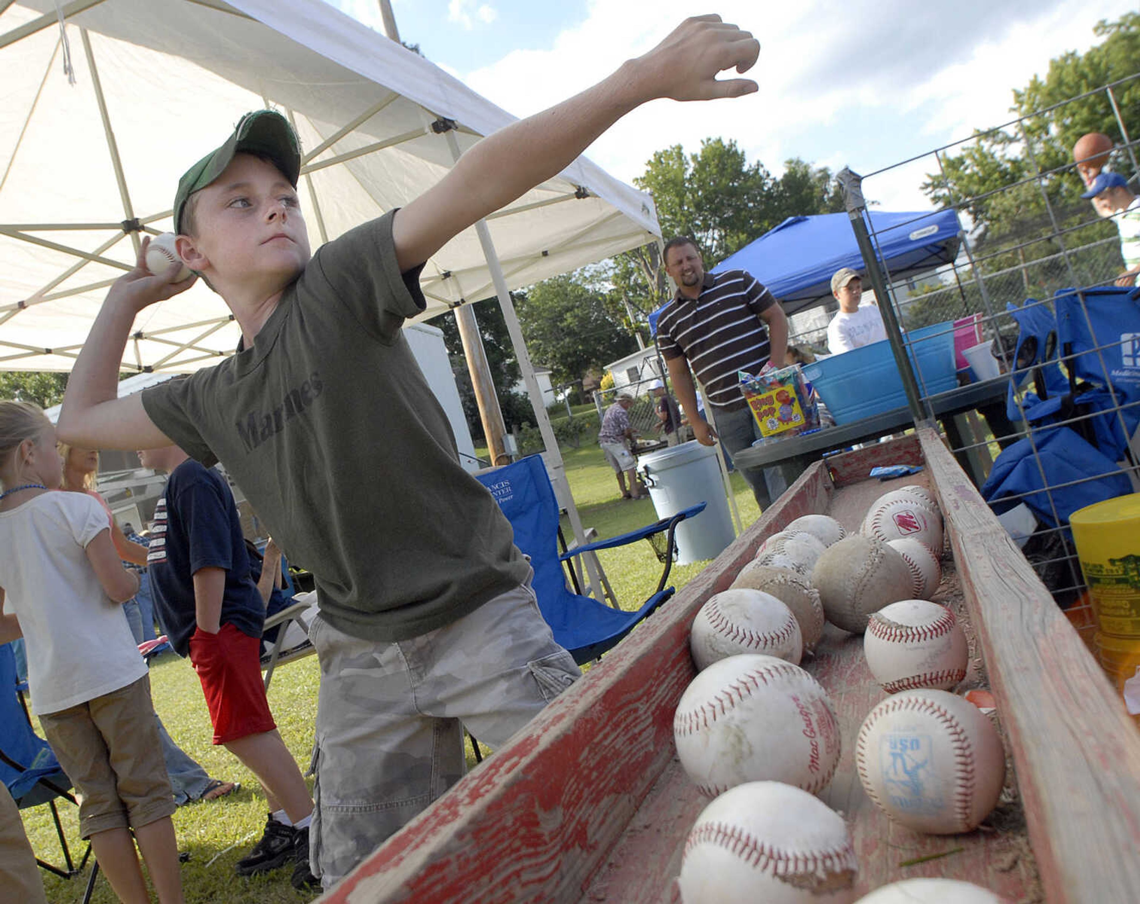 FRED LYNCH ~ flynch@semissourian.com
Bryce Dirnberger of New Hamburg tries his hand at the baseball toss booth Saturday at the New Hamburg Picnic.