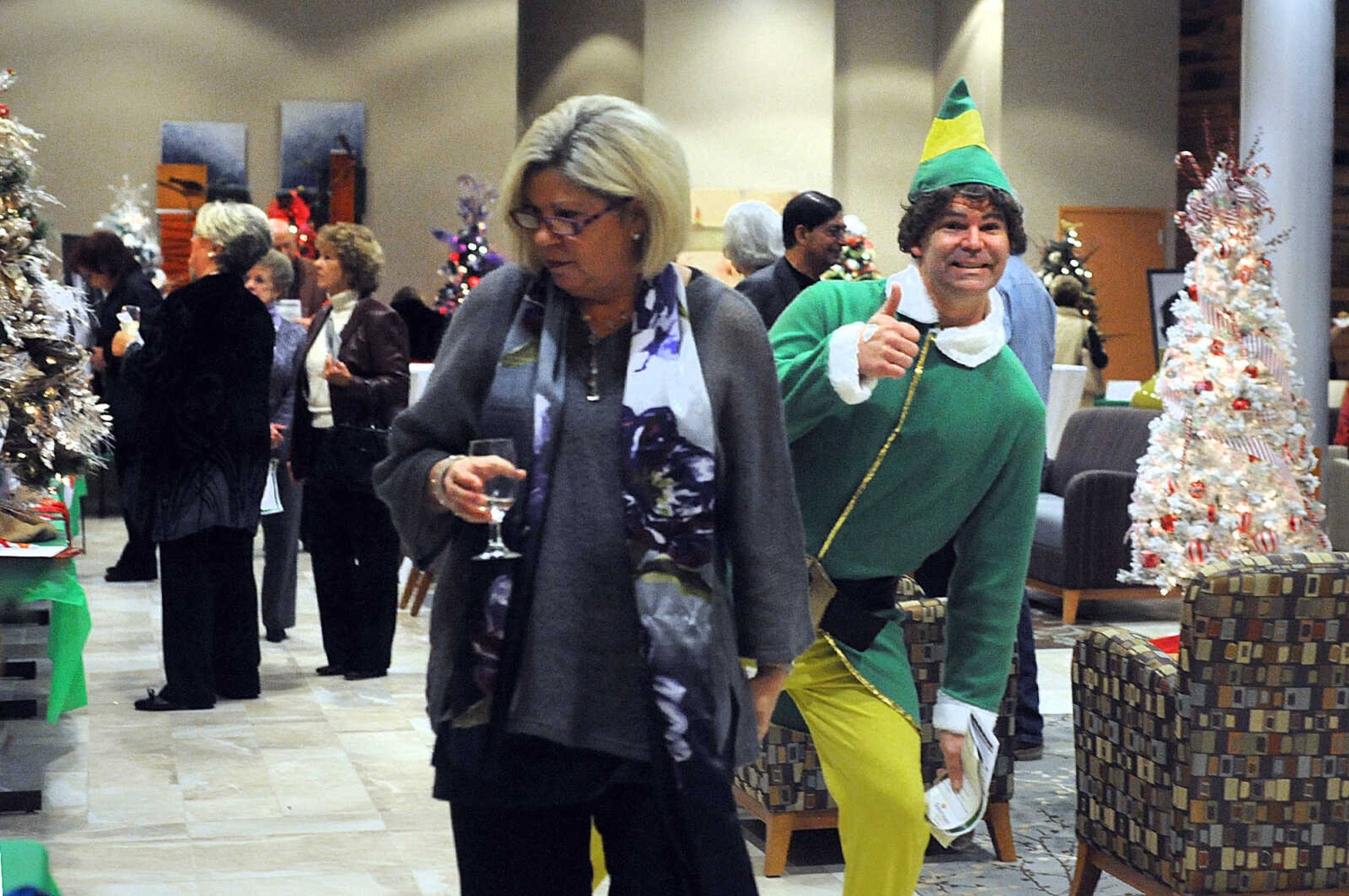 LAURA SIMON ~ lsimon@semissourian.com

Scott Givens mingles around attendees in his Elf costume, Saturday, Nov. 15, 2014, during the Festival of Trees sponsored by the SoutheastHEALTH Auxiliary at Southeast Cancer Center in Cape Girardeau. The event is a fundraiser for the expansion and redesign of the Level III Neonatal Care Unit at Southeast Hospital.