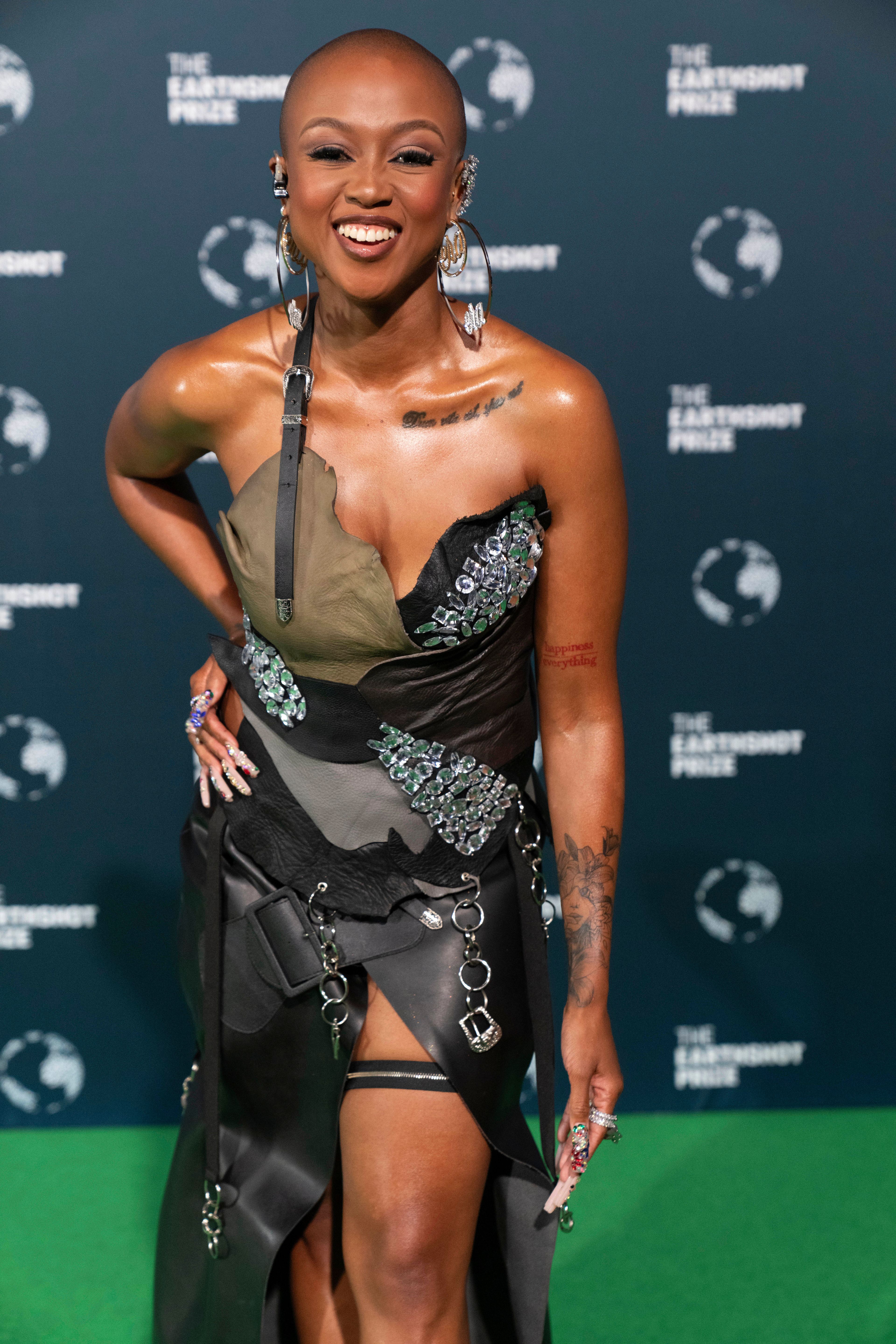 South African Rapper and Television host Moozlie poses on the green carpet before the start of the Earthshot Prize Award ceremony in Cape Town, South Africa, Wednesday, Nov. 6, 2024. (AP Photo/Jerome Delay)