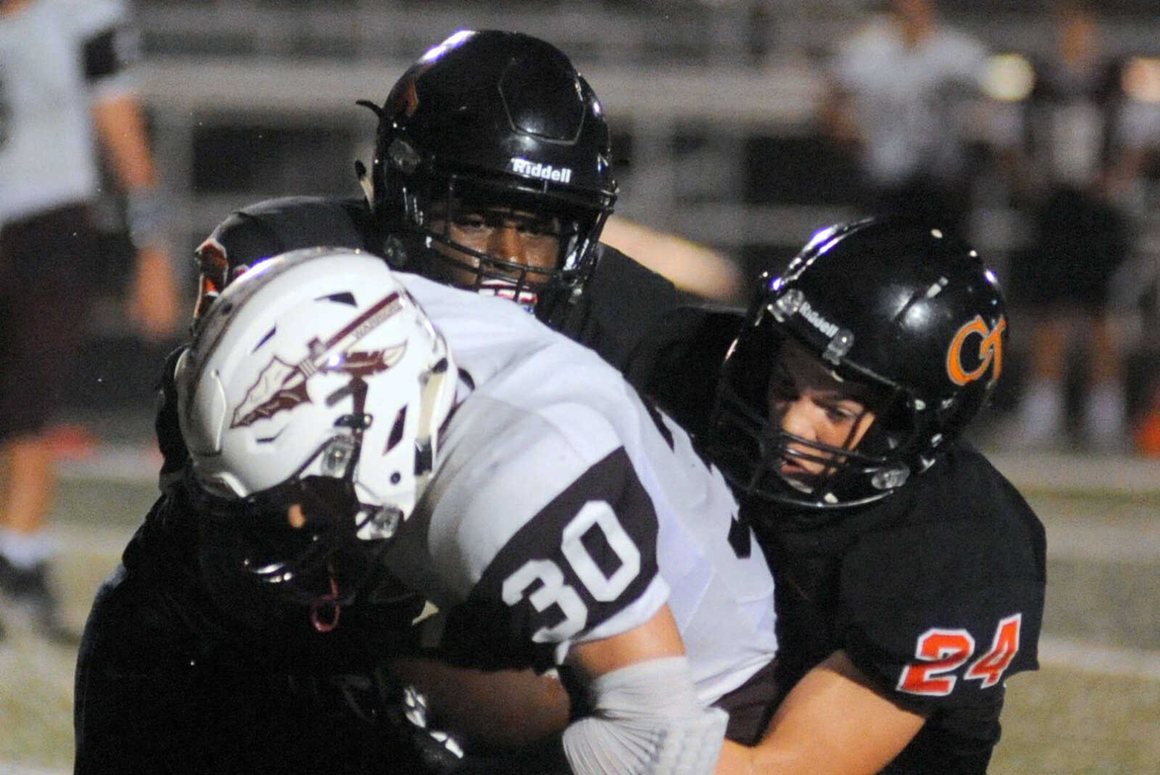 Cape Central's Aaron Harris, left and Matt Nussbaum combine to tackle St. Charles West's Brandon Carbray on Friday, August 26, 2016 at Cape Central High School. (Trent Singer)