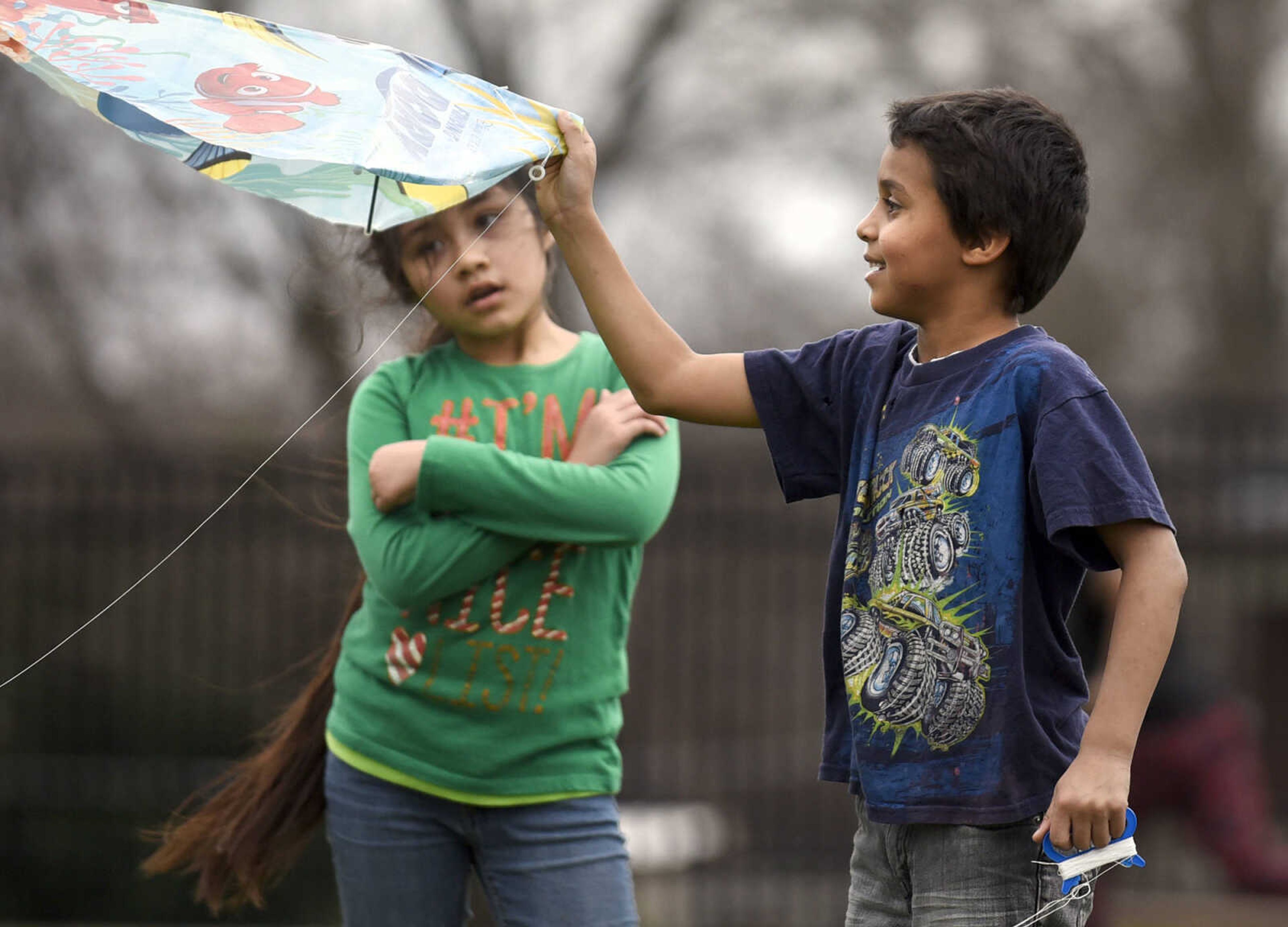 Morella Chanucoa waits for Devon Hines to get his kite airborne  on the playground on Friday, Feb. 24, 2017, at Franklin Elementary in Cape Girardeau. Lyndora Hughes second grade class spent a portion of the afternoon flying their kites as part of their story celebration for reading "Gloria Who Might Be My Best Friend".