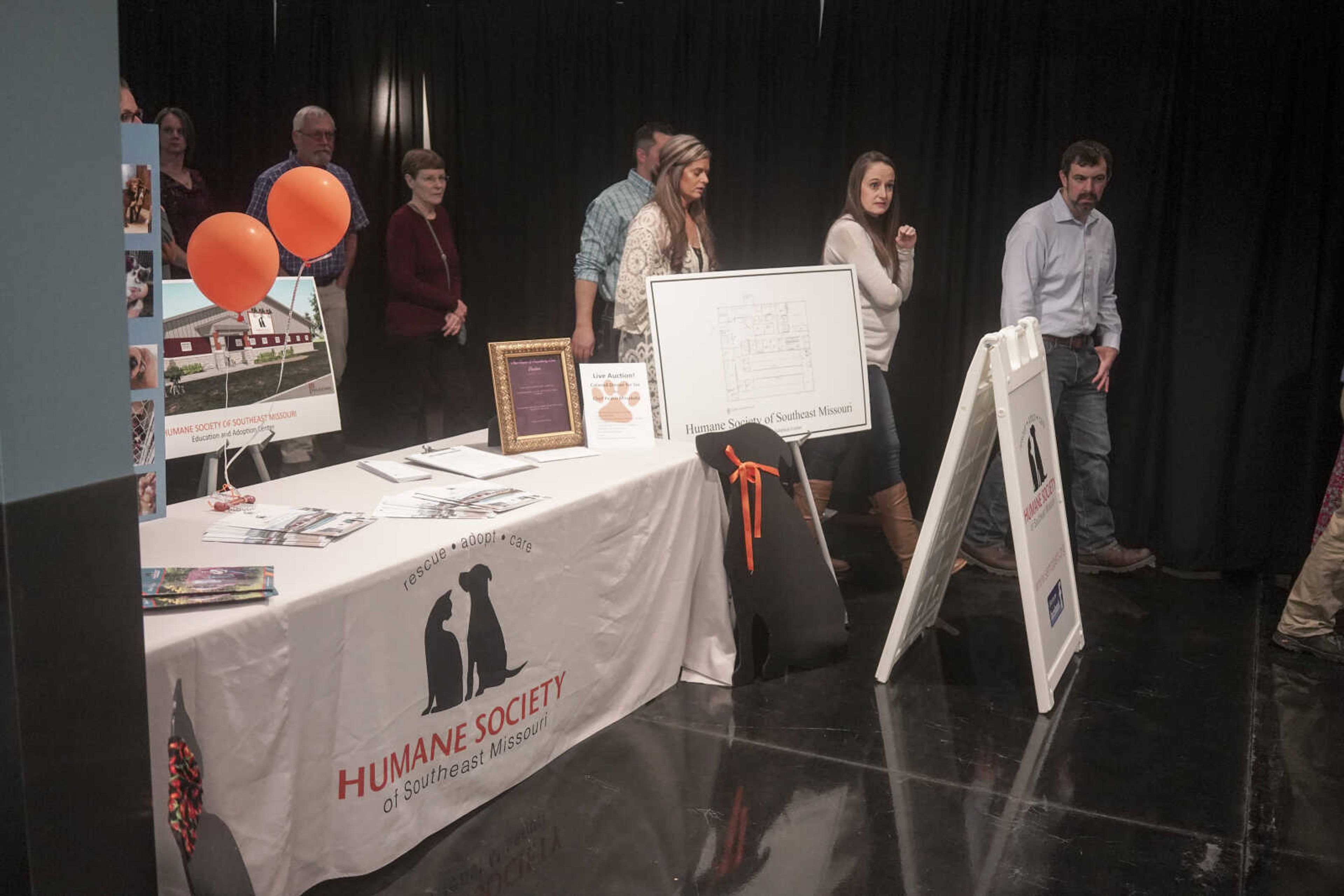 Attendees pass an informative booth during the Humane Society of Southeast Missouri Power of Pawsitivity fundraiser Saturday, Feb. 29, 2020, at the Jackson Civic Center in Jackson.