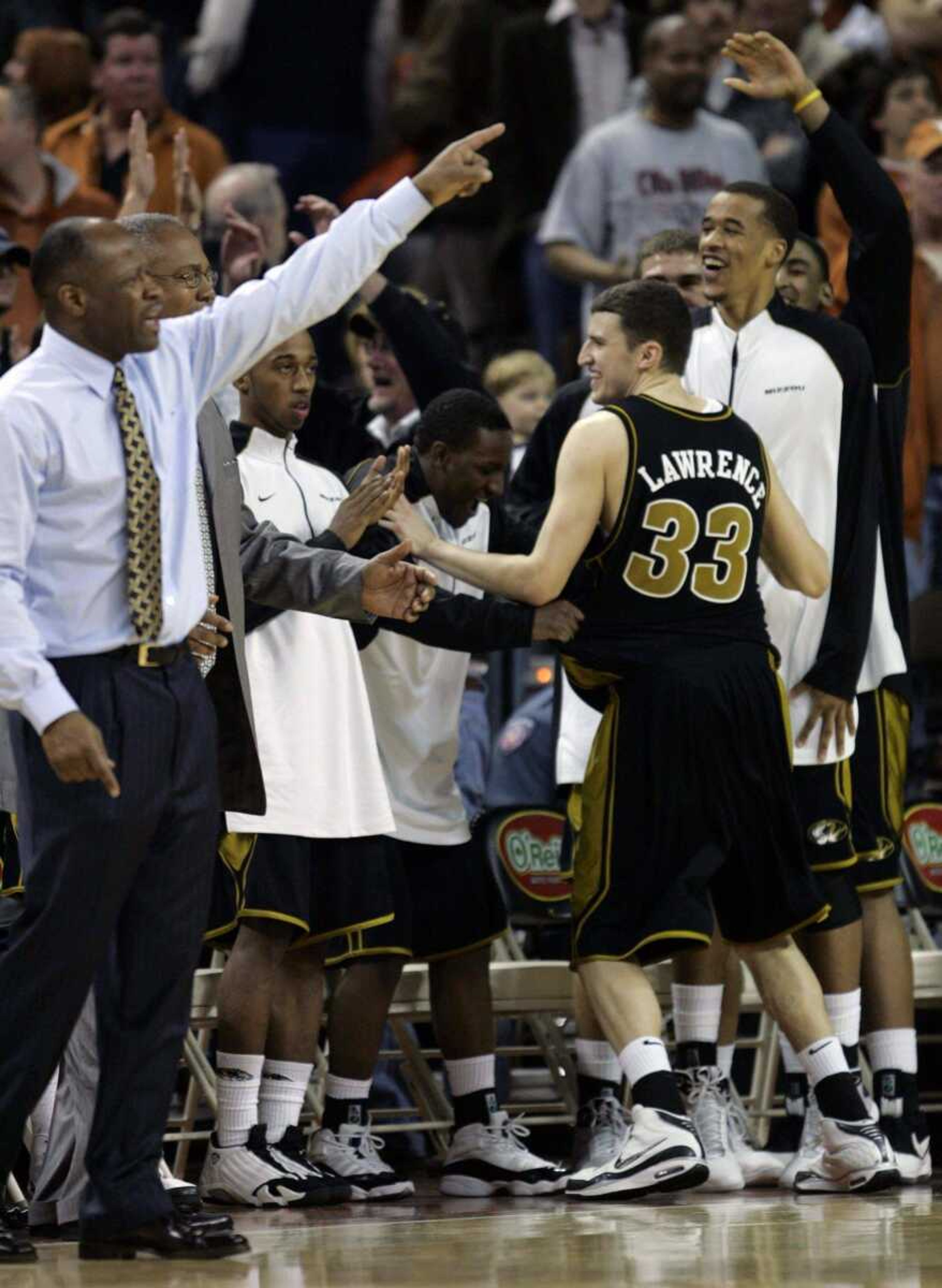 HARRY CABLUCK ~ Associated Press<br>The Missouri bench celebrates its 69-65 victory over Texas on Wednesday in Austin, Texas.