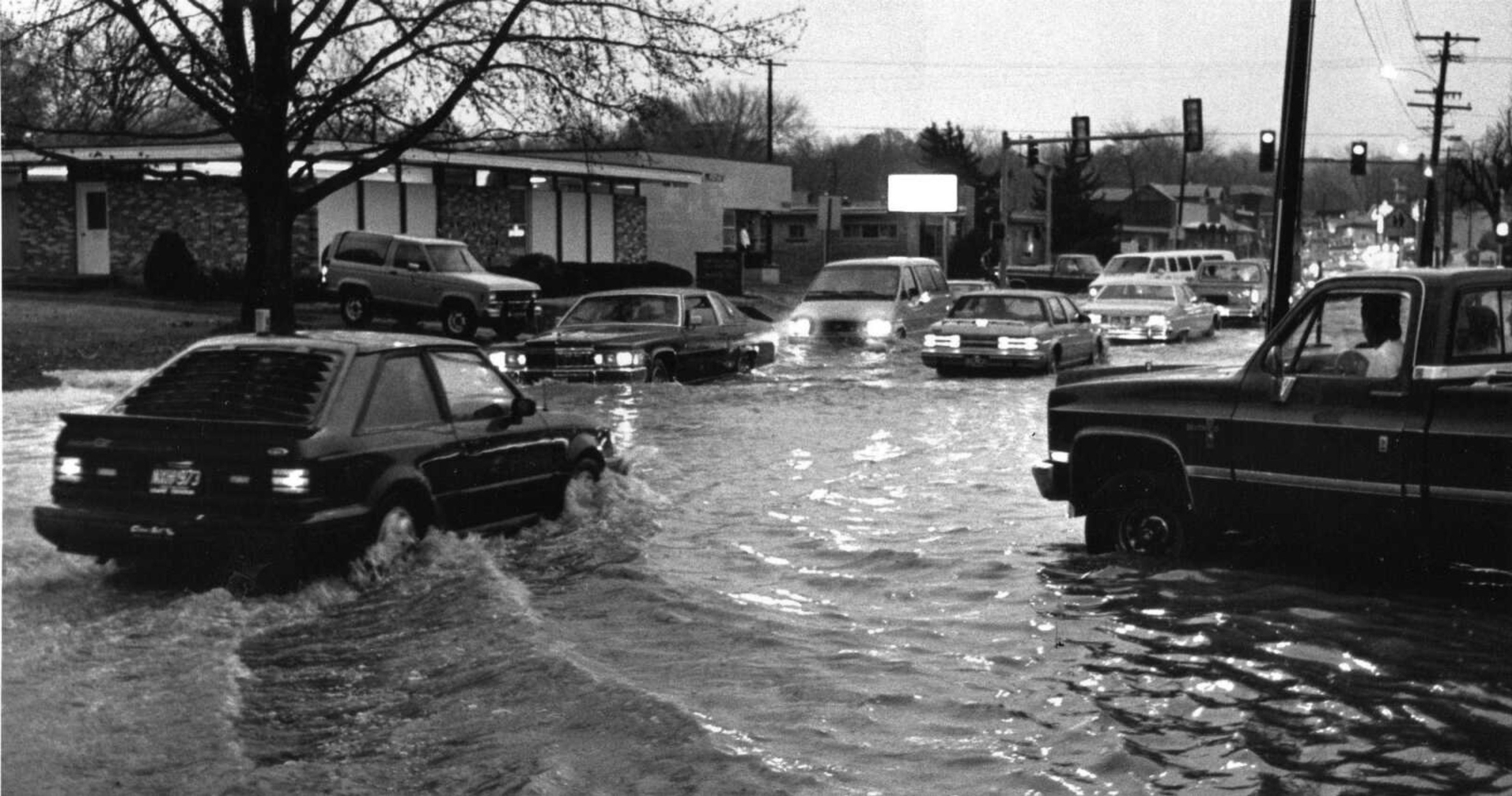 Nov. 20, 1991
Motorists cautiously drive through water over Broadway near Caruthers Avenue Tuesday afternoon during a rainstorm that flooded many intersections and stalled automobiles that were driven too fast for conditions. (Southeast Missourian, Fred Lynch)