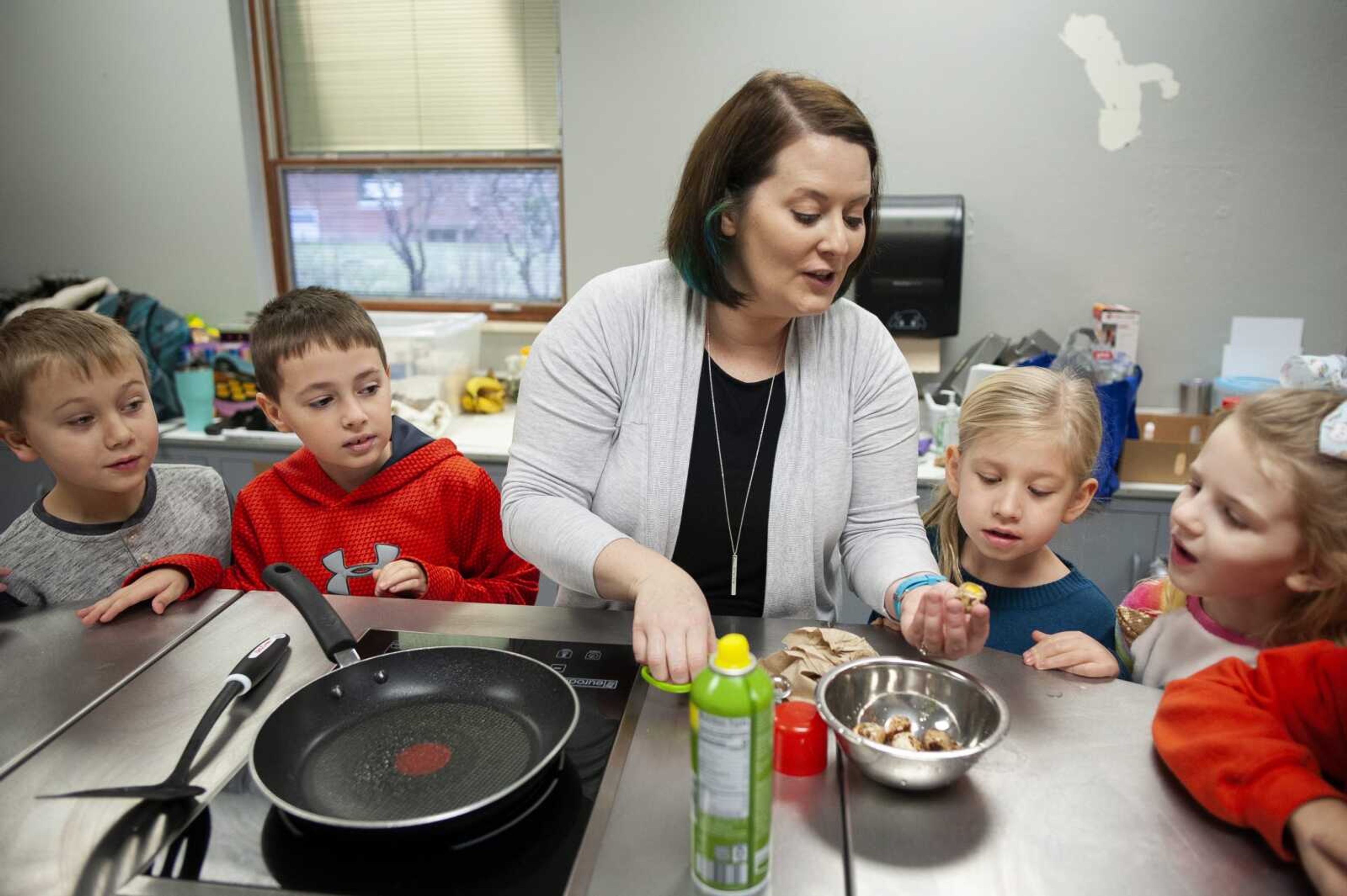 Resource reading title teacher Rachel Bentlage shows a quail egg for use in avocado toast to first-graders, from left, Max Drury, Gavin Ryan, Myla Crowden and Gia Dombrowski on Jan. 23 at Jefferson Elementary School in Cape Girardeau. Inspired by the book "Cloudy with a Chance of Meatballs" by Judi Barrett where food rains from the sky, Bentlage said students had the chance to make toast with quail eggs, taken from the quail housed at the school, or to construct a raft or house made out of food. The quail egg toast also featured fresh avocado. Bentlage said many of the kids have never tried avocado or a quail egg, and she wants the kids to have a "totally different experience."