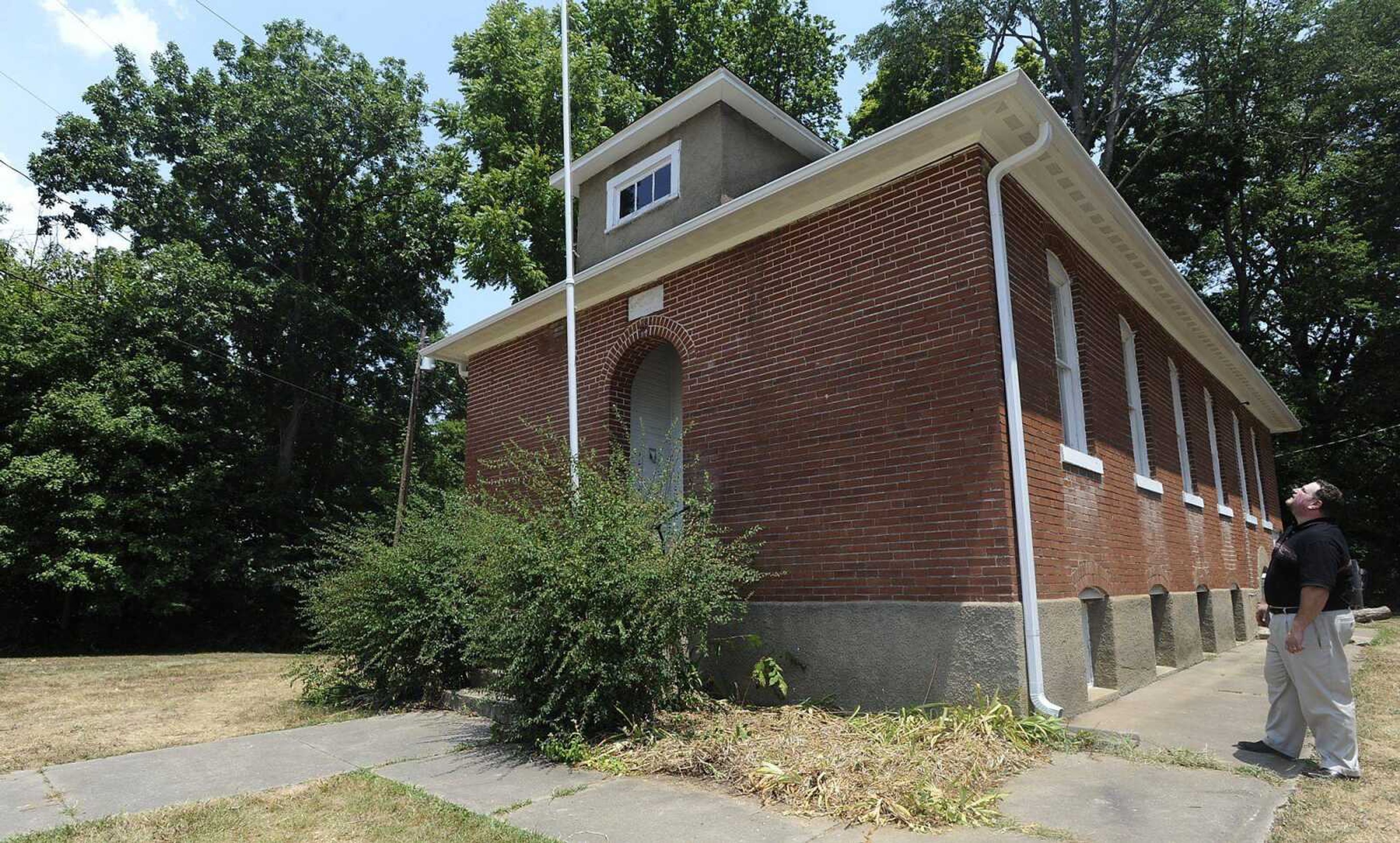 City planner Ryan Shrimplin examines some of the work that has been done on old Hanover Lutheran School. (ADAM VOGLER)