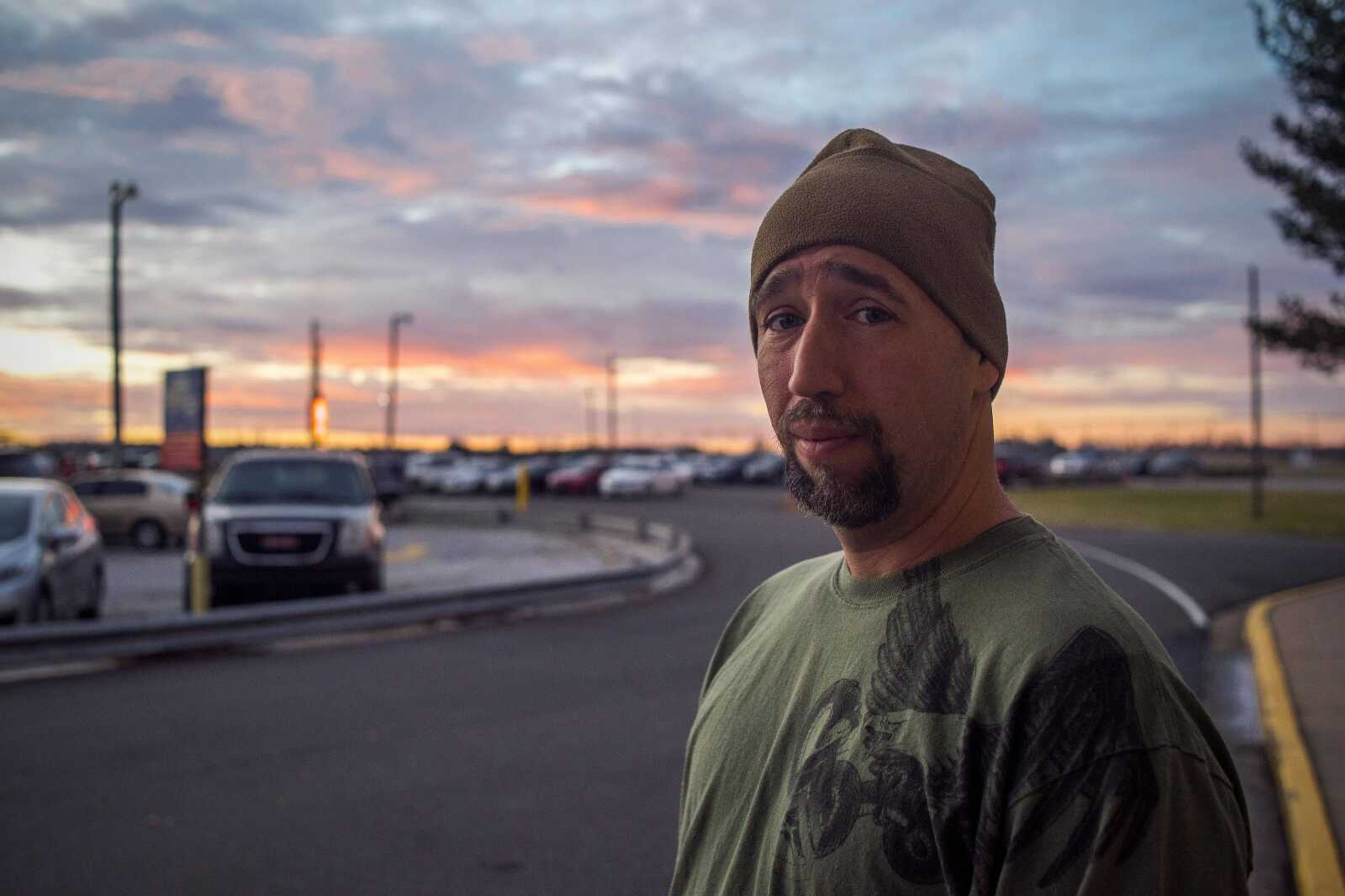 Robert Reynolds, a retired U.S. Marine staff sergeant who now works for the FAA at the airport in Paducah, Kentucky, poses for a portrait during a smoke break as dawn breaks over Barkley Regional Airport on the 17th day of the government shutdown, Monday, Jan. 7, 2019. Reynolds, whose responsibilities include many maintenance and logistical tasks for the airport, was among the government employees who were working without pay, but said he was confident he would receive all his back-pay. 
"I love my job and I love the federal government," he said, unperturbed. "I'm just not getting paid yet." He said he's just thankful he's not a government contractor like some of his friends, who are losing out thanks to the shutdown.