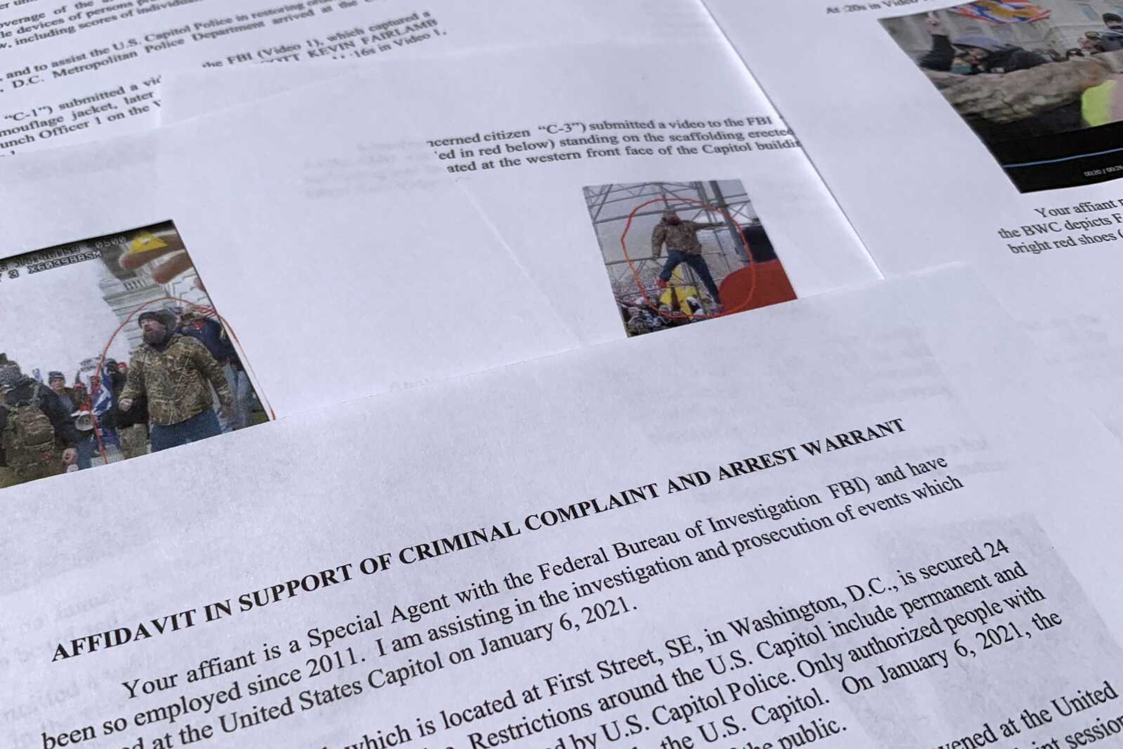 The affidavit from the FBI in support of an arrest warrant for Scott Kevin Fairlamb is photographed on Aug. 6, 2021. Fairlamb, a New Jersey gym owner who punched a police officer during the siege, raised more than $30,000 in online donations for a "atriot Relief Fund" to cover his mortgage payments and other monthly bills. Prosecutors cited the fund in recommending a fine for Fairlamb, who is serving a prison sentence of more than three years.