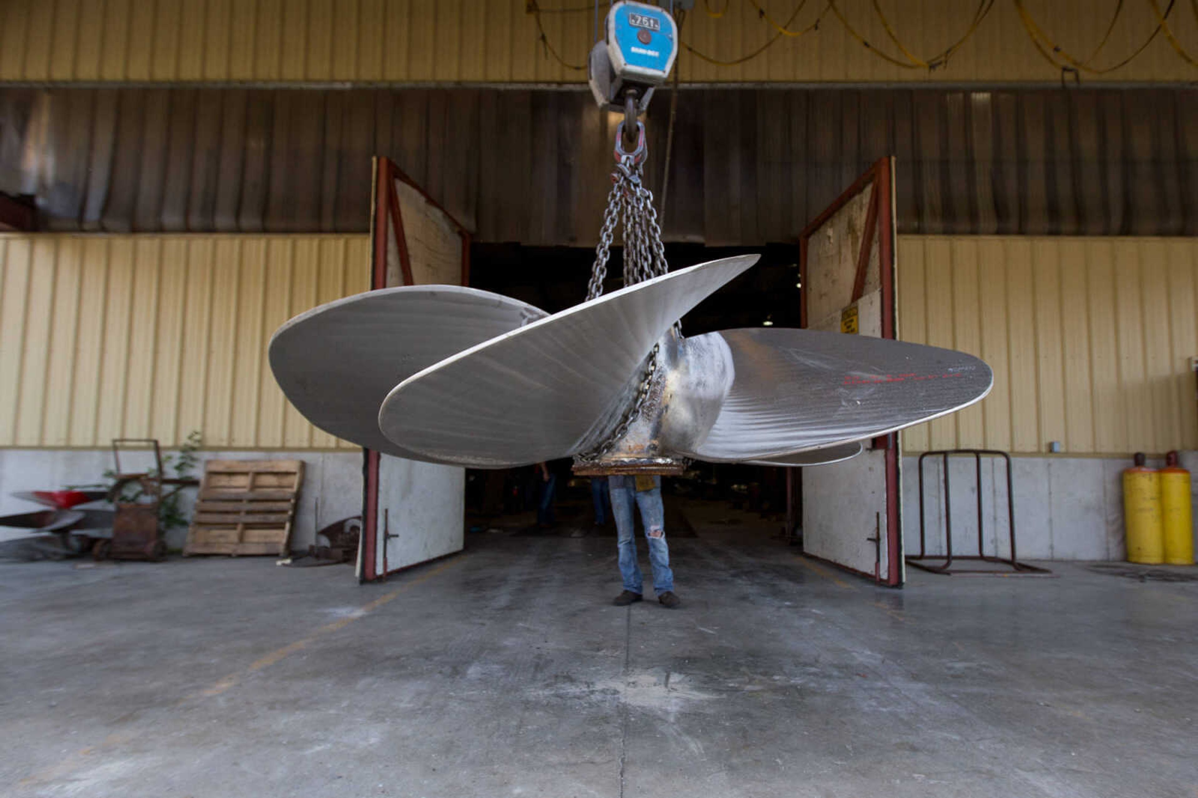 GLENN LANDBERG ~ glandberg@semissourian.com

Kyler Hale moves a propeller outside the repair shop at Missouri Dry Dock and Repair Co. in Cape Girardeau Wednesday, July 28, 2016.