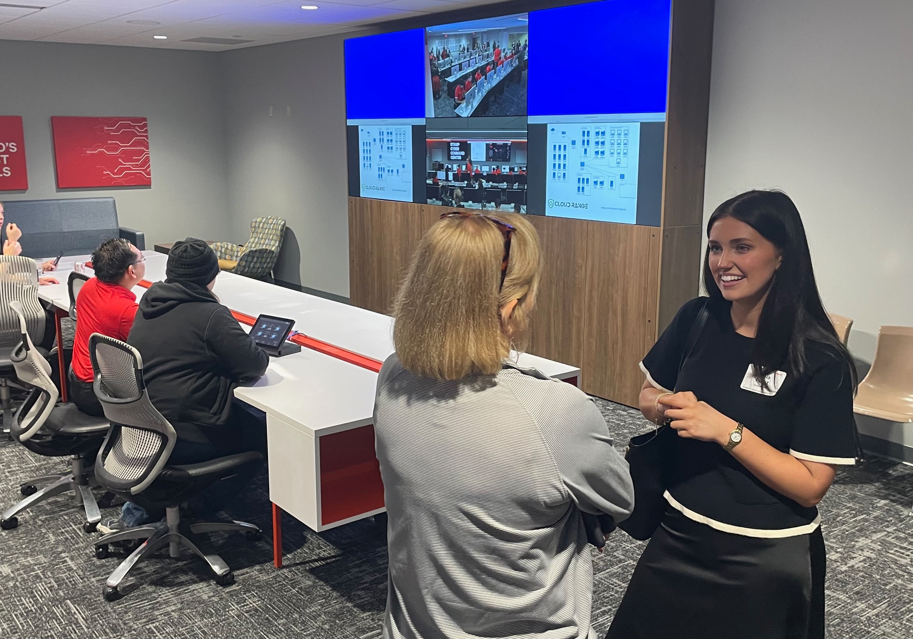 Student body president Lydia Pobst talks with congressional staff member Debbie Colyot in the observation room, adjacent to the command center.