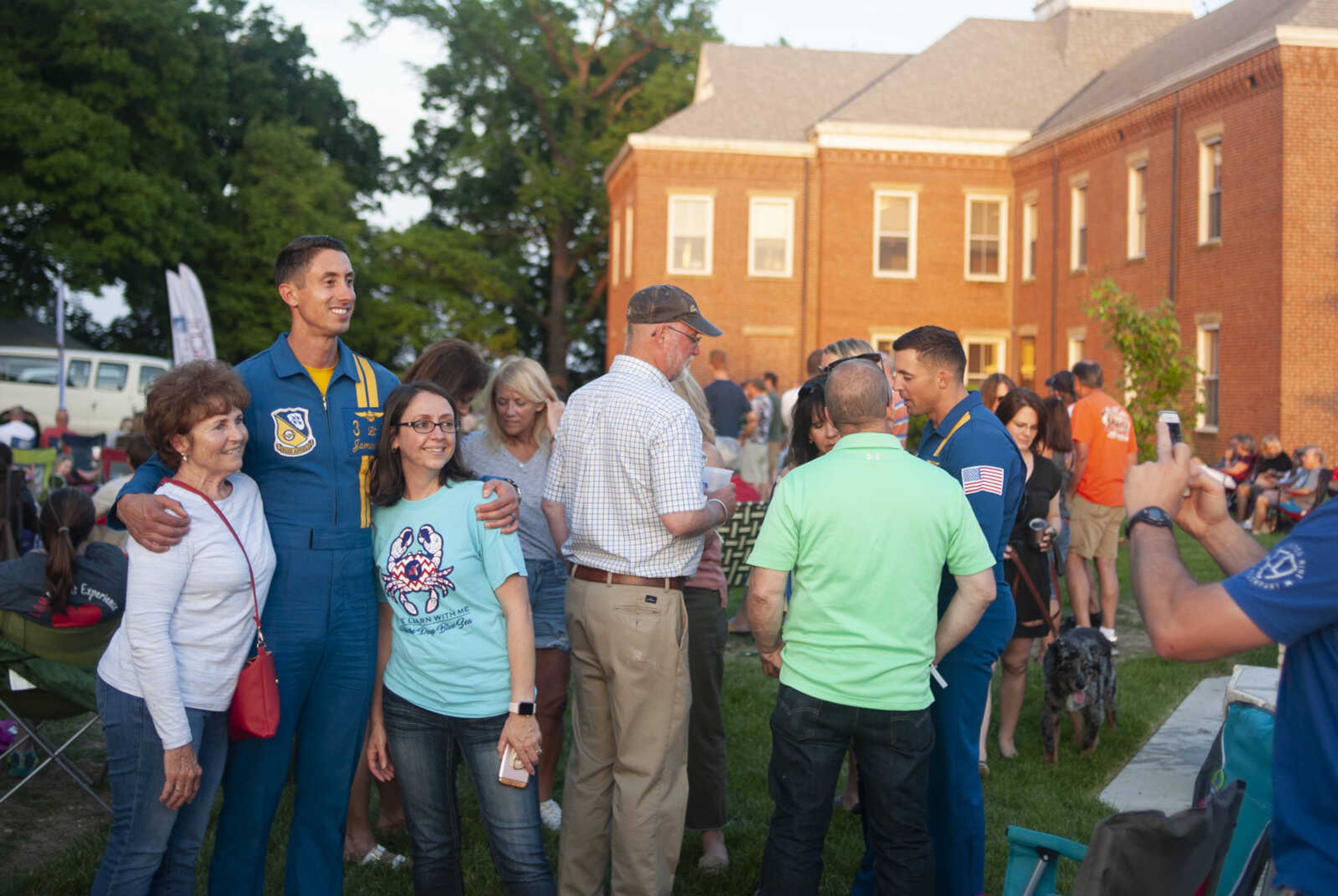 Sharon Brueckner of Cape Girardeau, left, and Amy Brueckner have a picture made with Blue Angels pilot Lt. James Cox during the season's first Tunes at Twilight on Friday, May 17, 2019, at Ivers Square near Common Pleas Courthouse in Cape Girardeau.