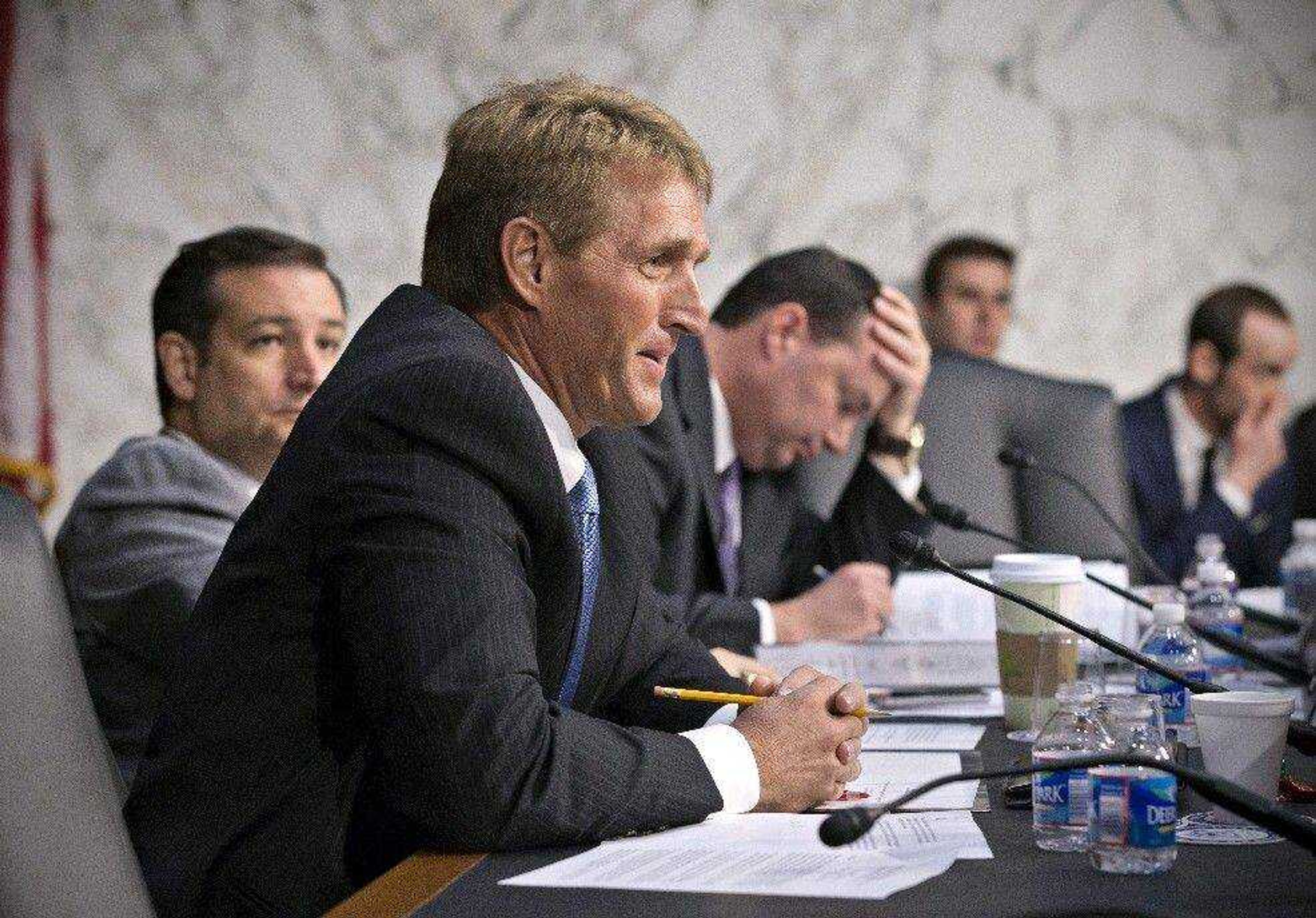 Senate Judiciary Committee member Sen. Jeff Flake, R-Ariz., center, flanked by Sen. Mike Lee, R-Utah, right, and Sen. Ted Cruz, R-Texas, questions Homeland Security Secretary Janet Napolitano on Tuesday on Capitol Hill during the committee&#8217;s hearing on immigration reform. (J. Scott Applewhite ~ Associated Press)