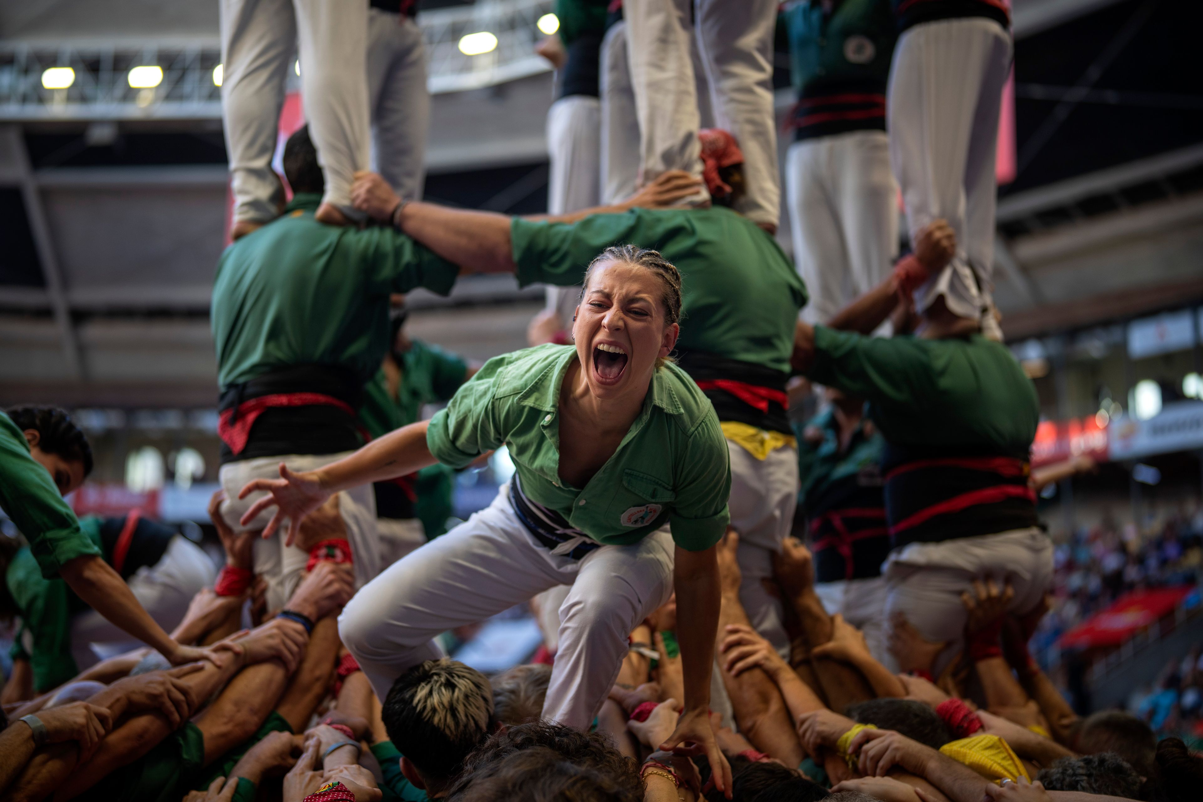 Members of "Castellers de Sant Cugat" react after successfully completing their "Castell", during the 29th Human Tower Competition in Tarragona, Spain, Saturday, Oct. 5, 2024. (AP Photo/Emilio Morenatti)