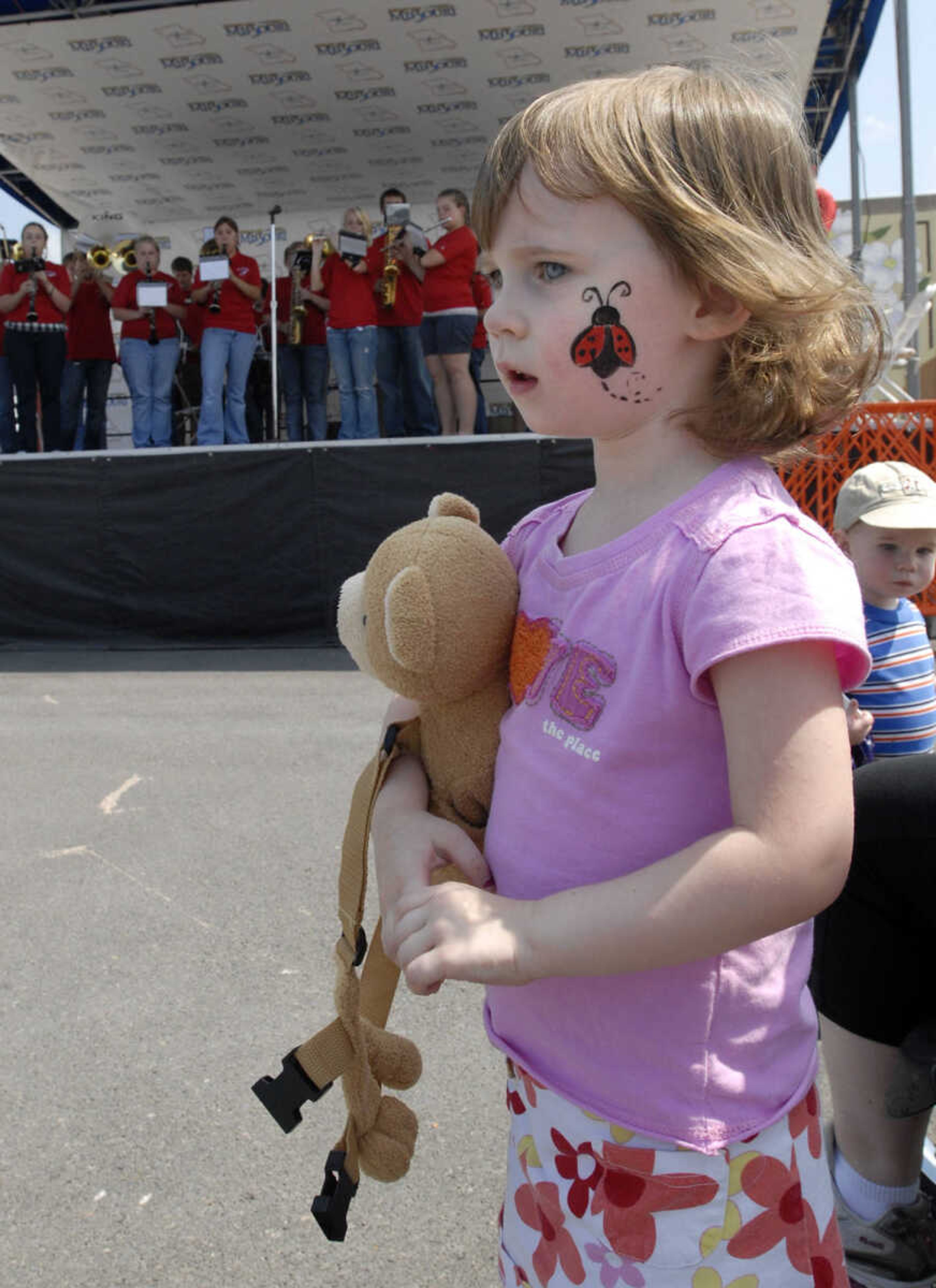 Marianne Dean, 3, of Cape Girardeau got her face painted in downtown Cape Girardeau prior to the finish of the Tour of Missouri.