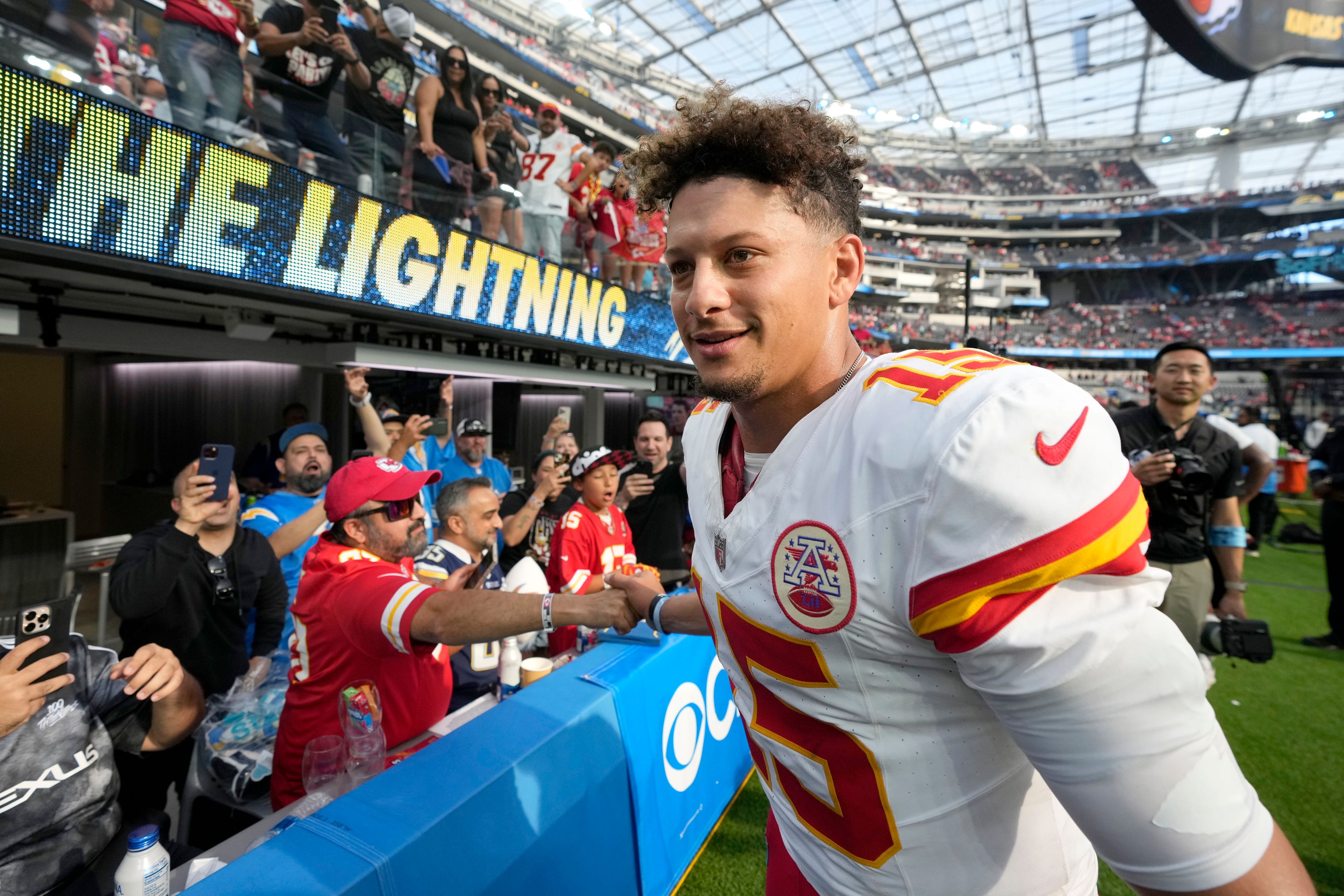 Kansas City Chiefs quarterback Patrick Mahomes fist bumps fans as he heads off the field following an NFL football game against the Los Angeles Chargers Sunday, Sept. 29, 2024, in Inglewood, Calif. The Chiefs won 17-10. (AP Photo/Marcio Jose Sanchez)