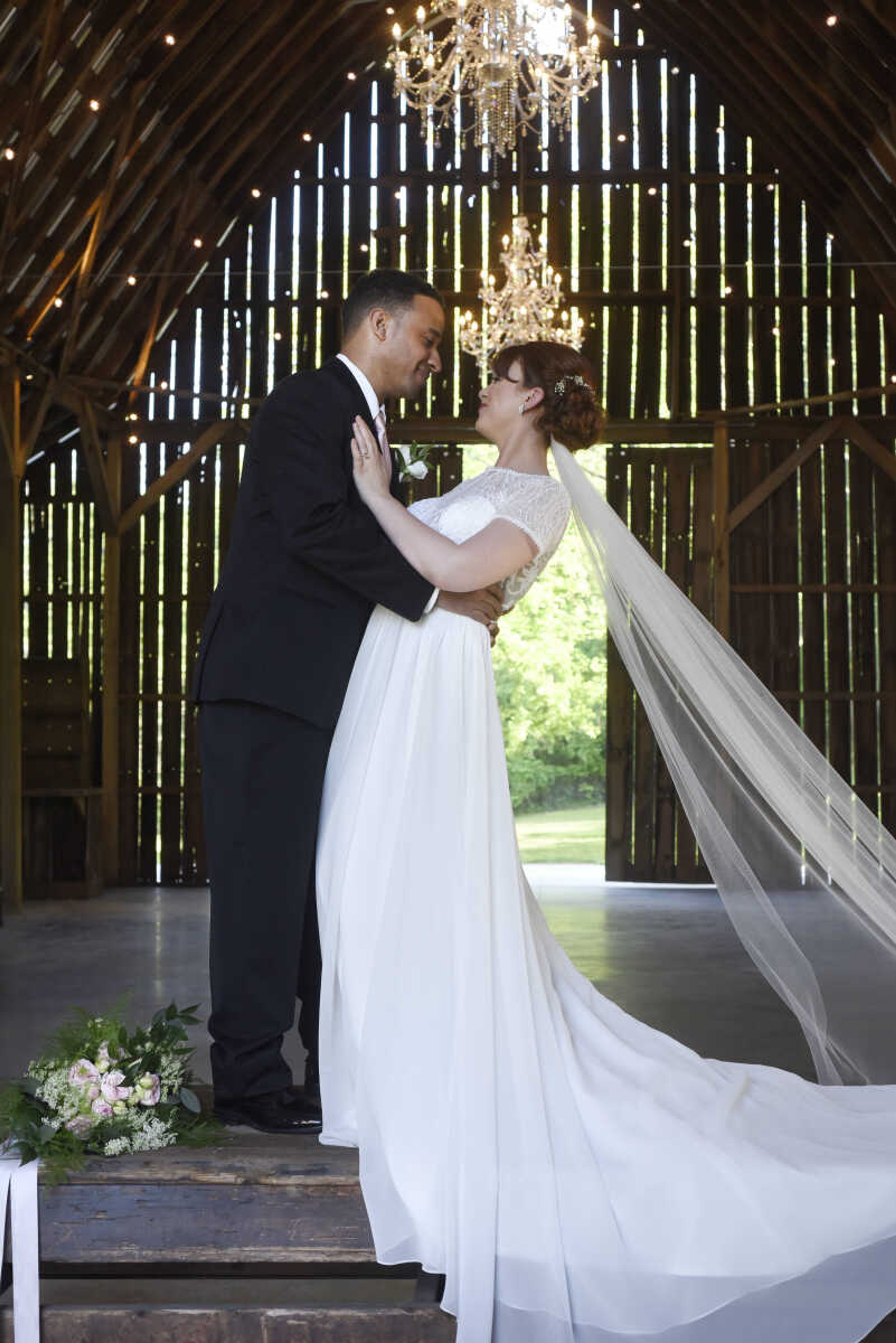 Ti Adora : Style 7700 
Ivory Chiffon A-line bridal gown. Embroidered bodice with an illusion sweetheart neckline, cap sleeves and covered buttons. Available at Magnolias Bridal Boutique in Cape Girardeau.

Wedding suits courtesy of Jim's Formal Wear and available at Garber's Men's Wear in Cape Girardeau.