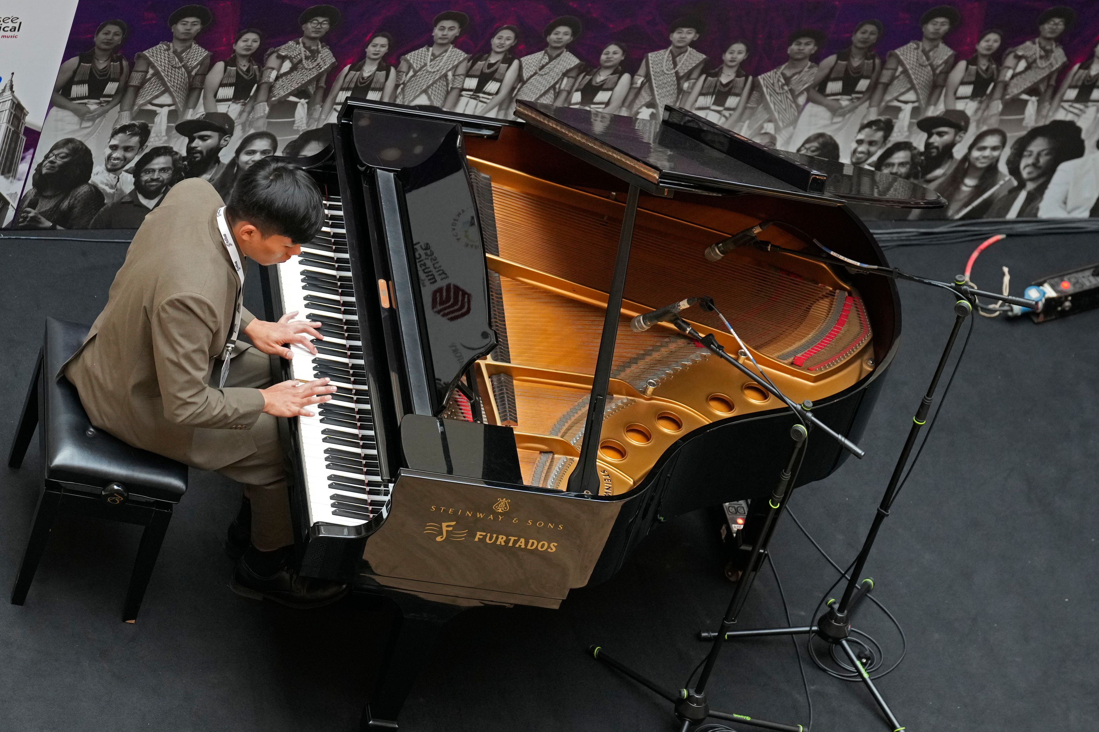 Takosangba Jamir, 27, a blind pianist, performs at a shopping mall during the two-day Brillante Piano Festival in Bengaluru, India, Sunday, Sept. 29, 2024. (AP Photo/Aijaz Rahi)