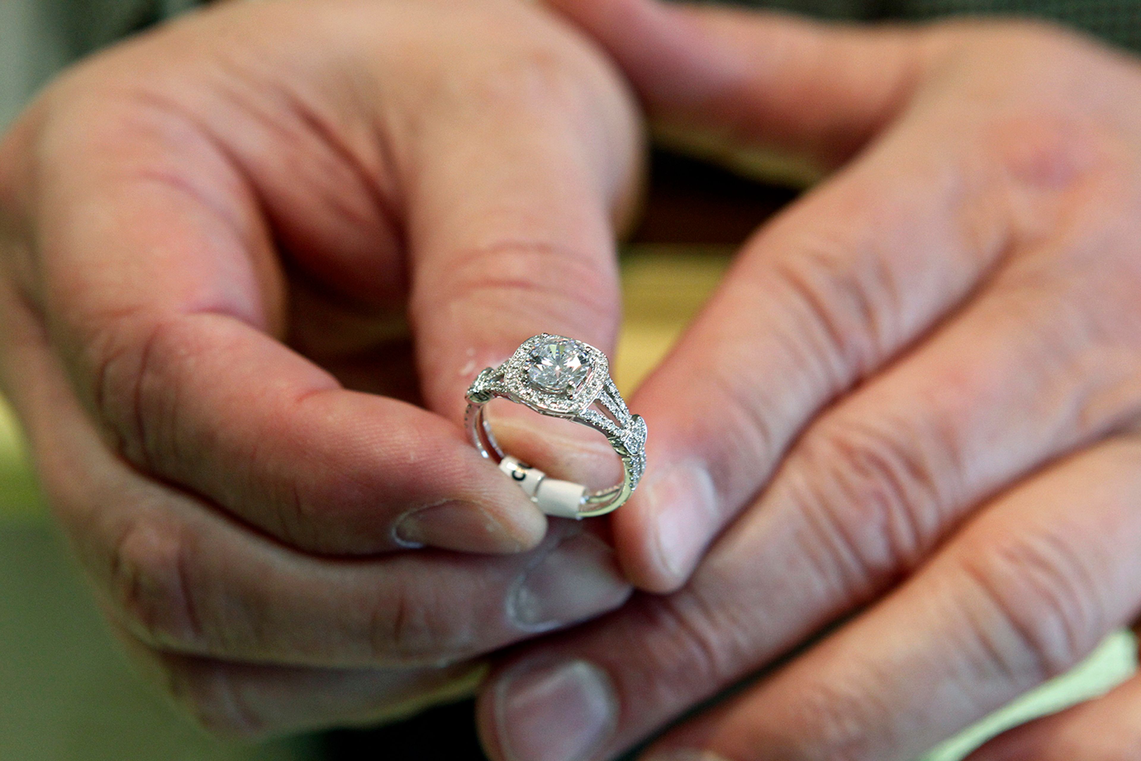 FILE - A jewelers displays an engagement ring on May 14, 2014, in Jacksonville, N.C. (Maria Sestito/The Daily News via AP, File)