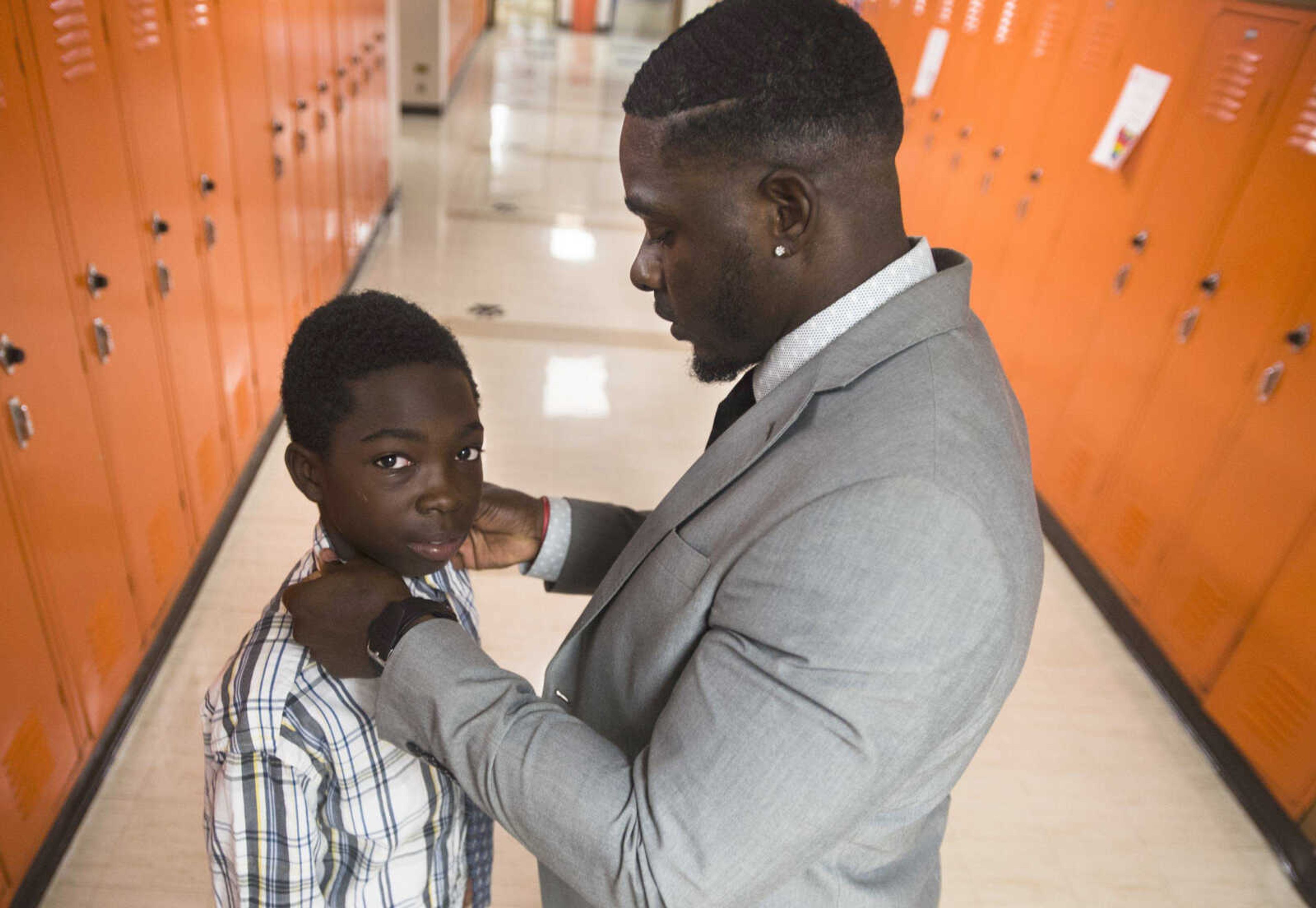 In this photo from 2017, Honorable Young Men Club co-founder Cantrell Andrews ties a knot for Lemuel Gilbert at Central Middle School in Cape Girardeau.