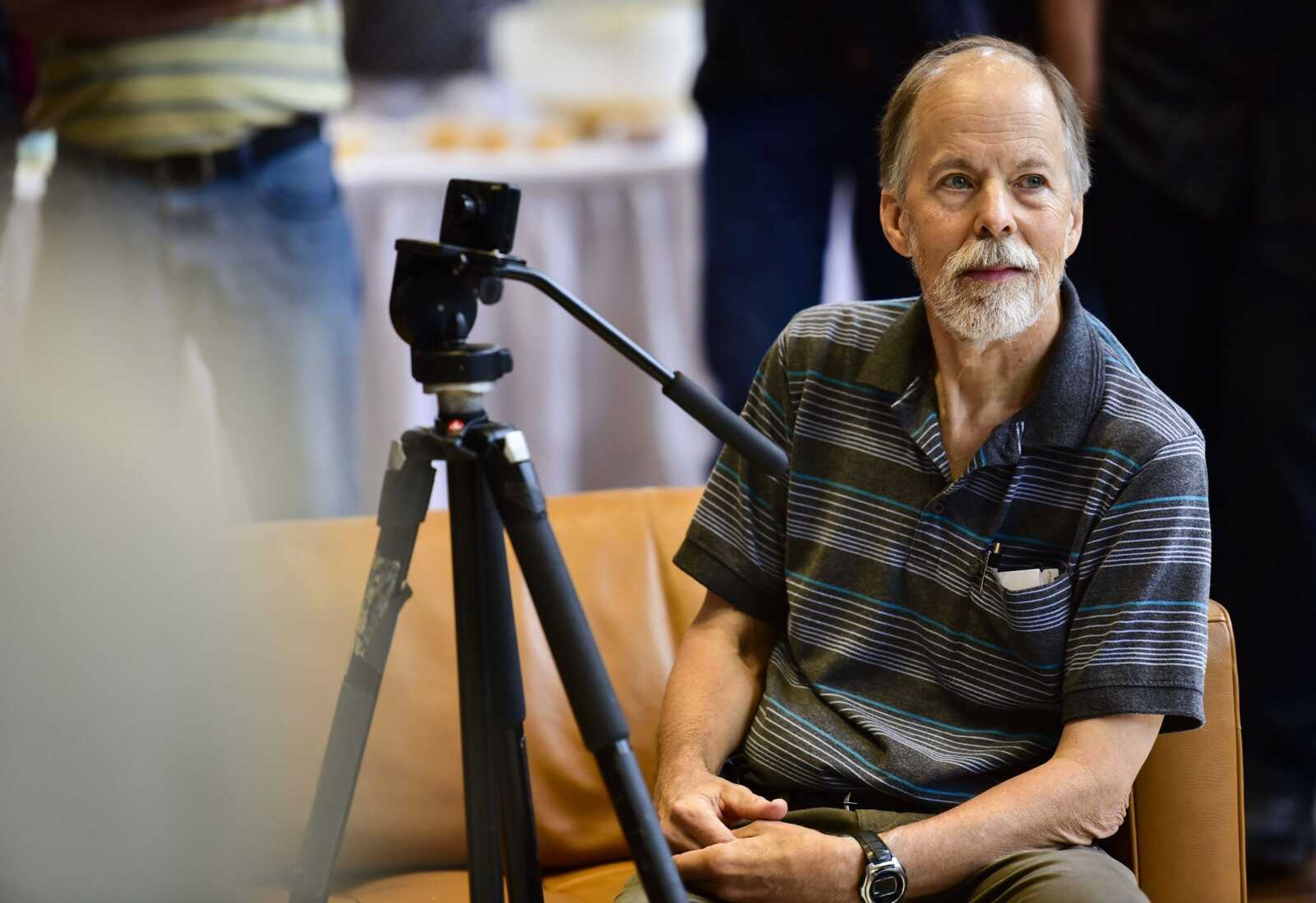 Fred Lynch listens as Southeast Missourian editor Bob Miller speaks during a retirement celebration at the Rust Center for Media in Cape Girardeau. Lynch retired Friday after 43 years as a photojournalist for the Southeast Missourian.