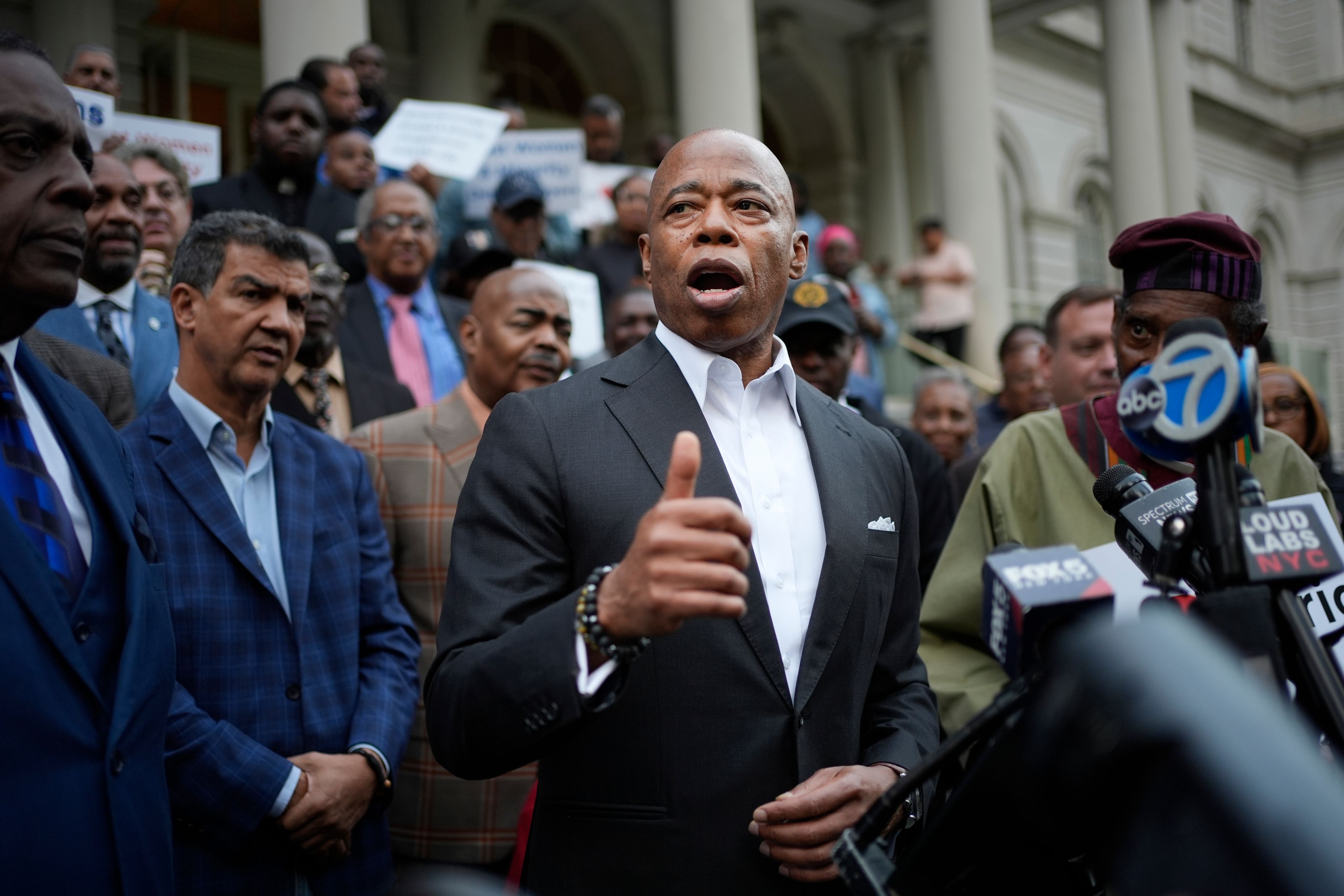 New York City Mayor Eric Adams speaks while surrounded by faith leaders and other supporters during a rally and prayer vigil on the steps of City Hall in New York, Tuesday, Oct. 1, 2024. (AP Photo/Seth Wenig)