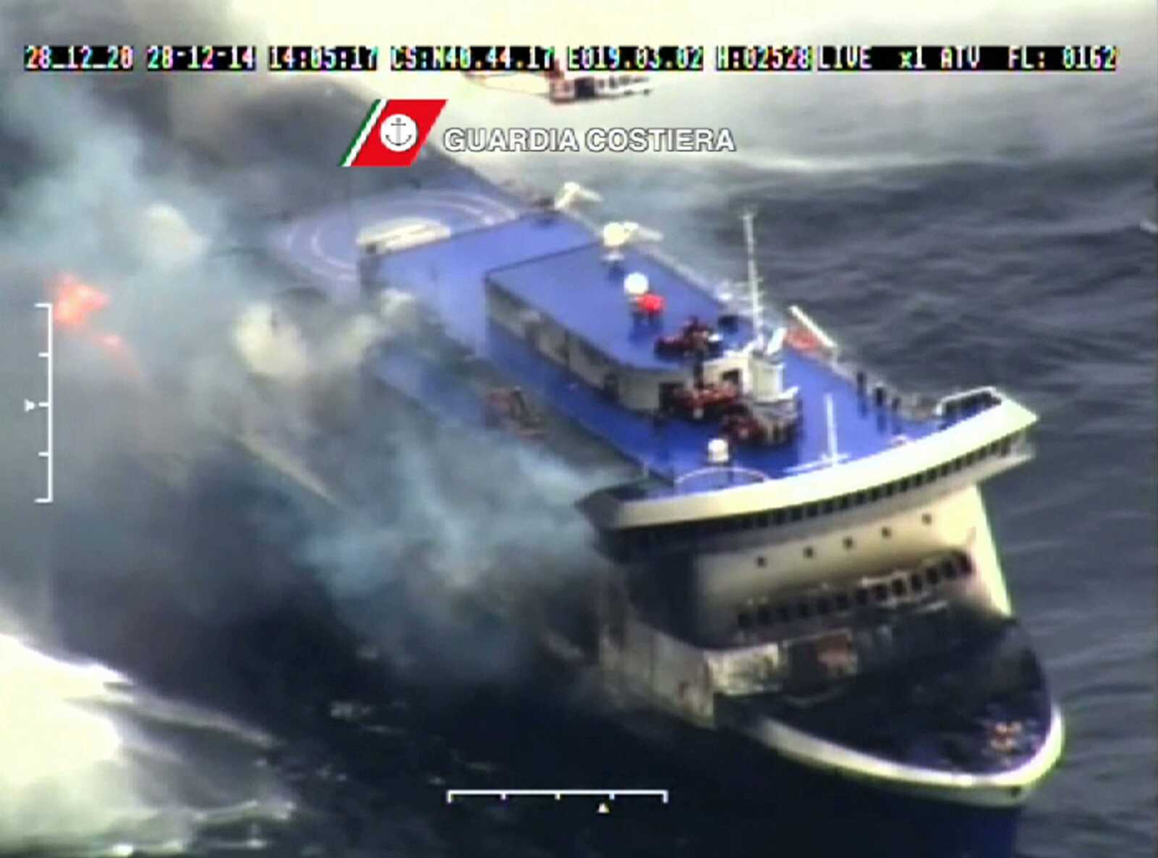 In this image taken from a video released by the Italian Coast Guard, smoke billows from the Italian-flagged Norman Atlantic that caught fire in the Adriatic Sea, Sunday, Dec. 28, 2014. Italian and Greek rescue crews battled gale-force winds and massive waves as they struggled Sunday to evacuate hundreds of people from a ferry on fire and adrift in the channel between Italy and Albania. At least one person died and two were injured. The fire broke out before dawn Sunday on a car deck of the Italian-flagged Norman Atlantic, traveling from the western Greek port of Patras to the Italian port of Ancona on the Adriatic, with 422 passengers and 56 crew members on board. (AP Photo/Italian Coast Guard)