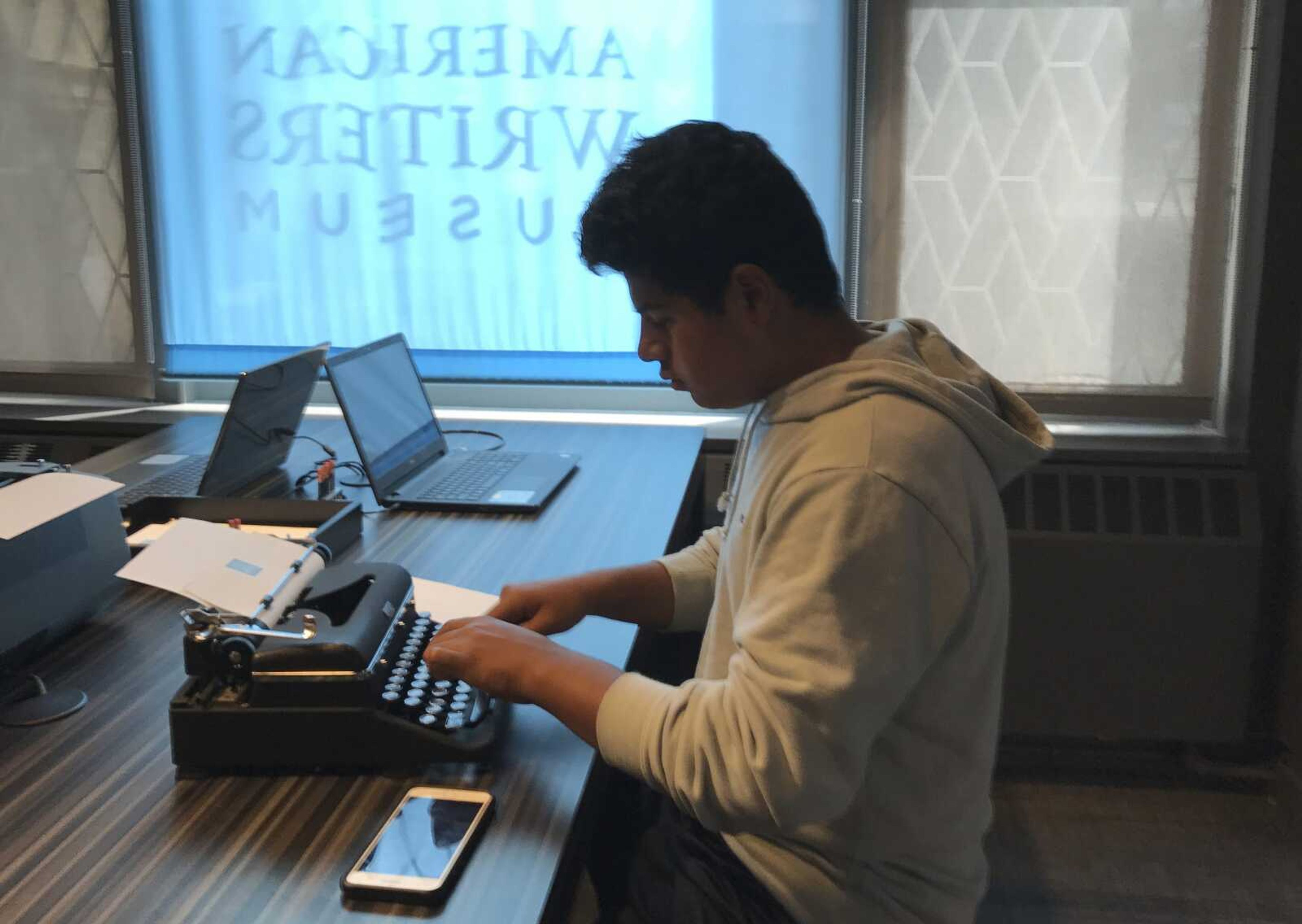 A teenage visitor uses a typewriter on display at the American Writers Museum on Aug. 10, 2017, in Chicago. A younger generation is discovering the joy of the feel and sound of the typewriter.